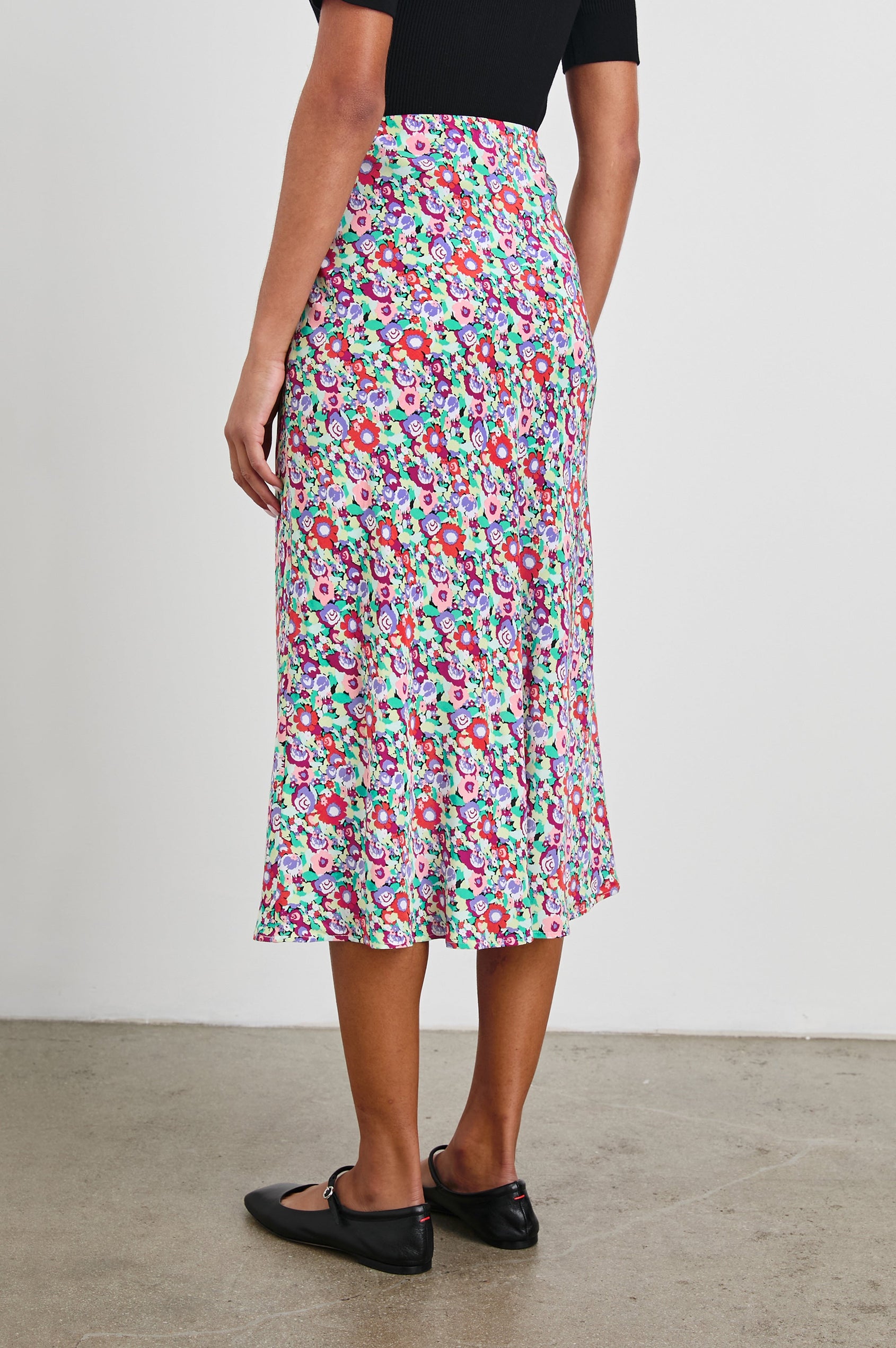 Rosetta Midi Skirt with White Buttons Down the Front in Oversized Multi Floral Colorway, Red, Purple Pinks and Green - Back View Featured on Model