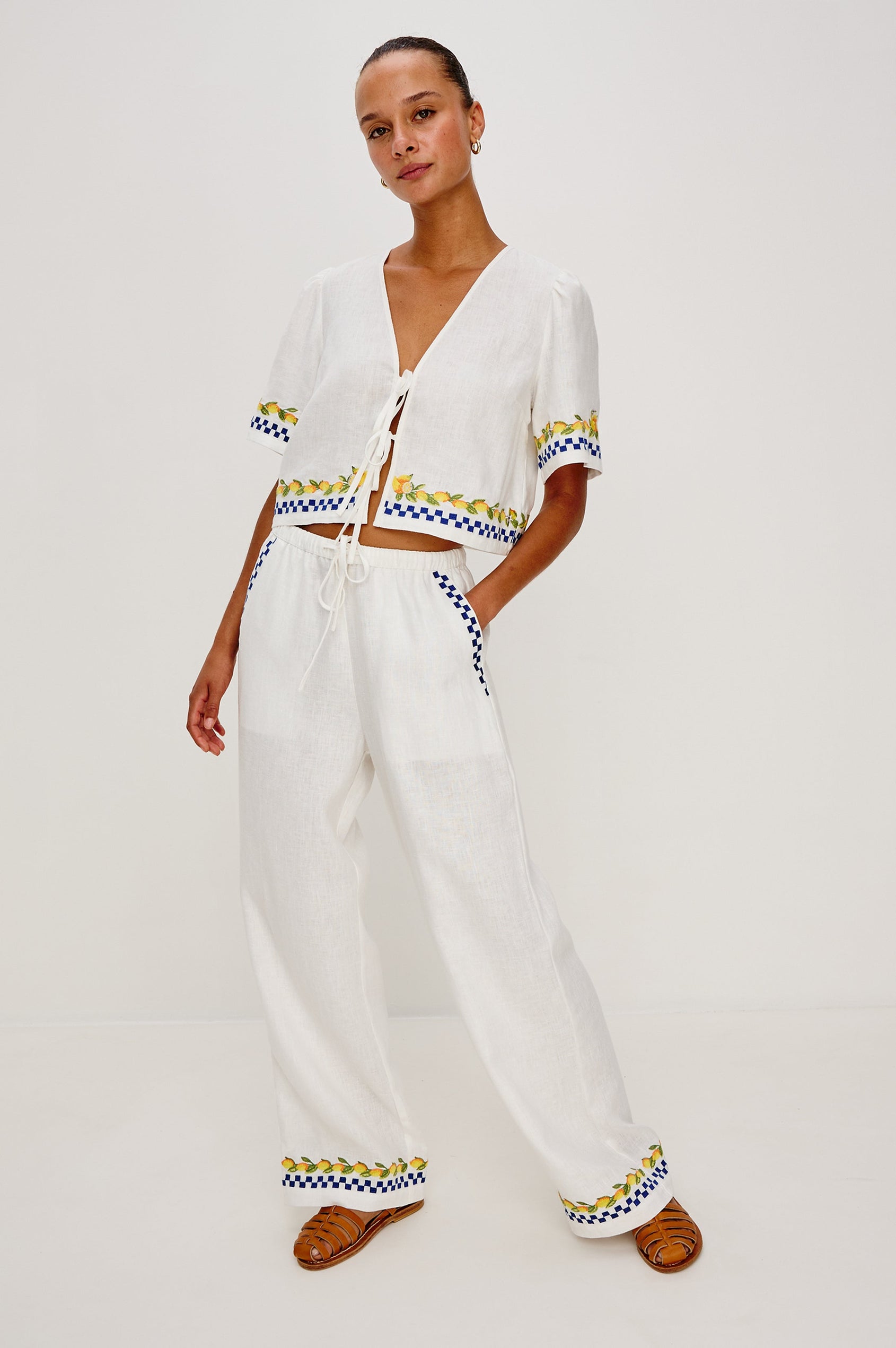 Rosita linen pant in Sorrento Embroidery colorway featuring side pockets, drawstring waist, and Italian inspired embroidery - Full body front view on model