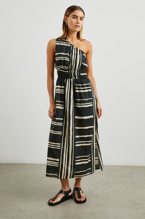 Selani Midi Dress With an Asymmetrical Neckline, Mid-Thigh Slide Slit and Cinched Waistband in Island Stripe Colorway, with alternating white and black horizontal and vertical stripes - Front Full Body View Featured on Model