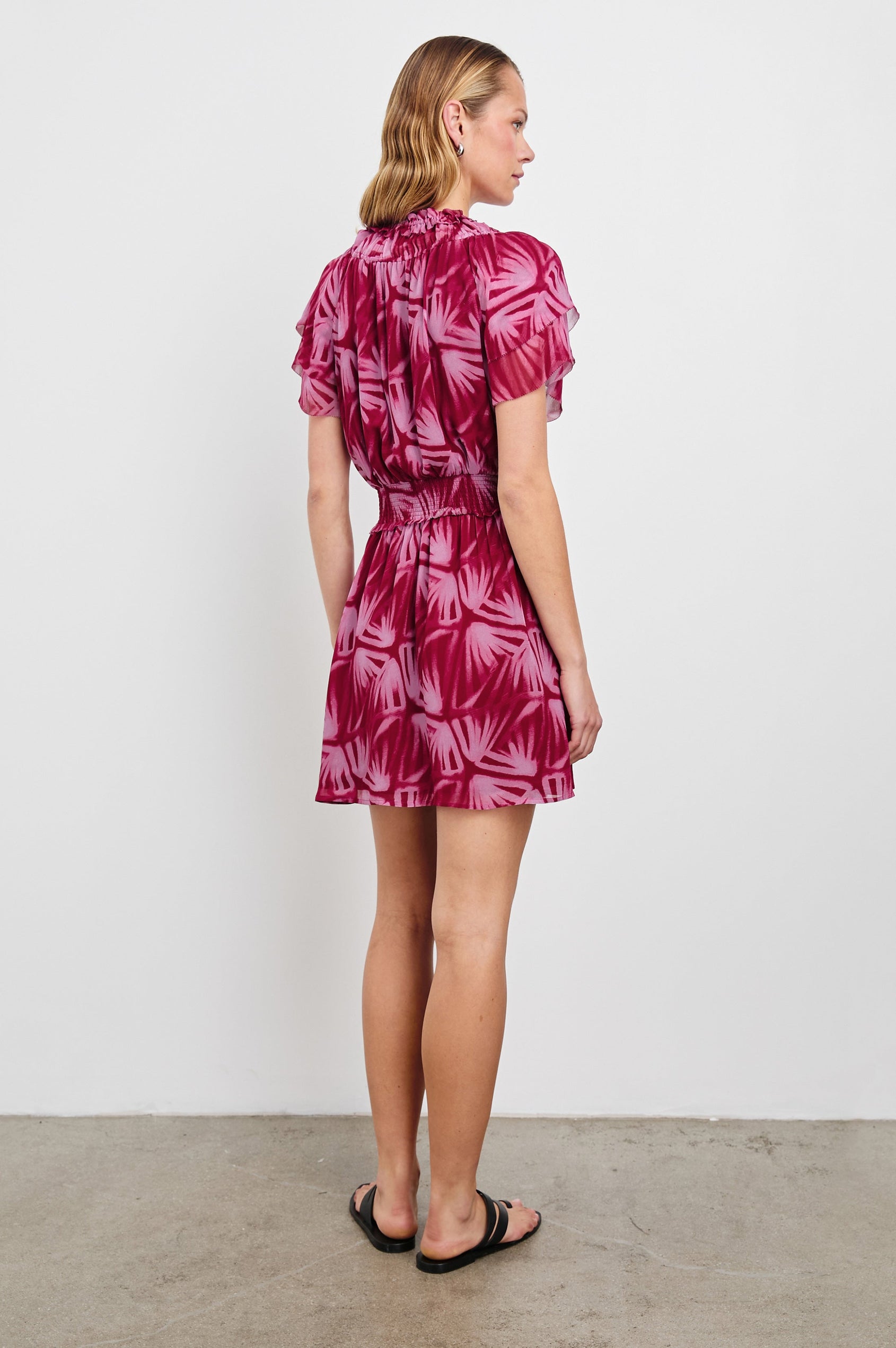 Terrin Mid-Thigh Dress with Ruffled Sleeves, a V Neck, and Shirred Collar and Waist in Bahia Colorway, a pattern in pinks - Back Full Body View Featured on model