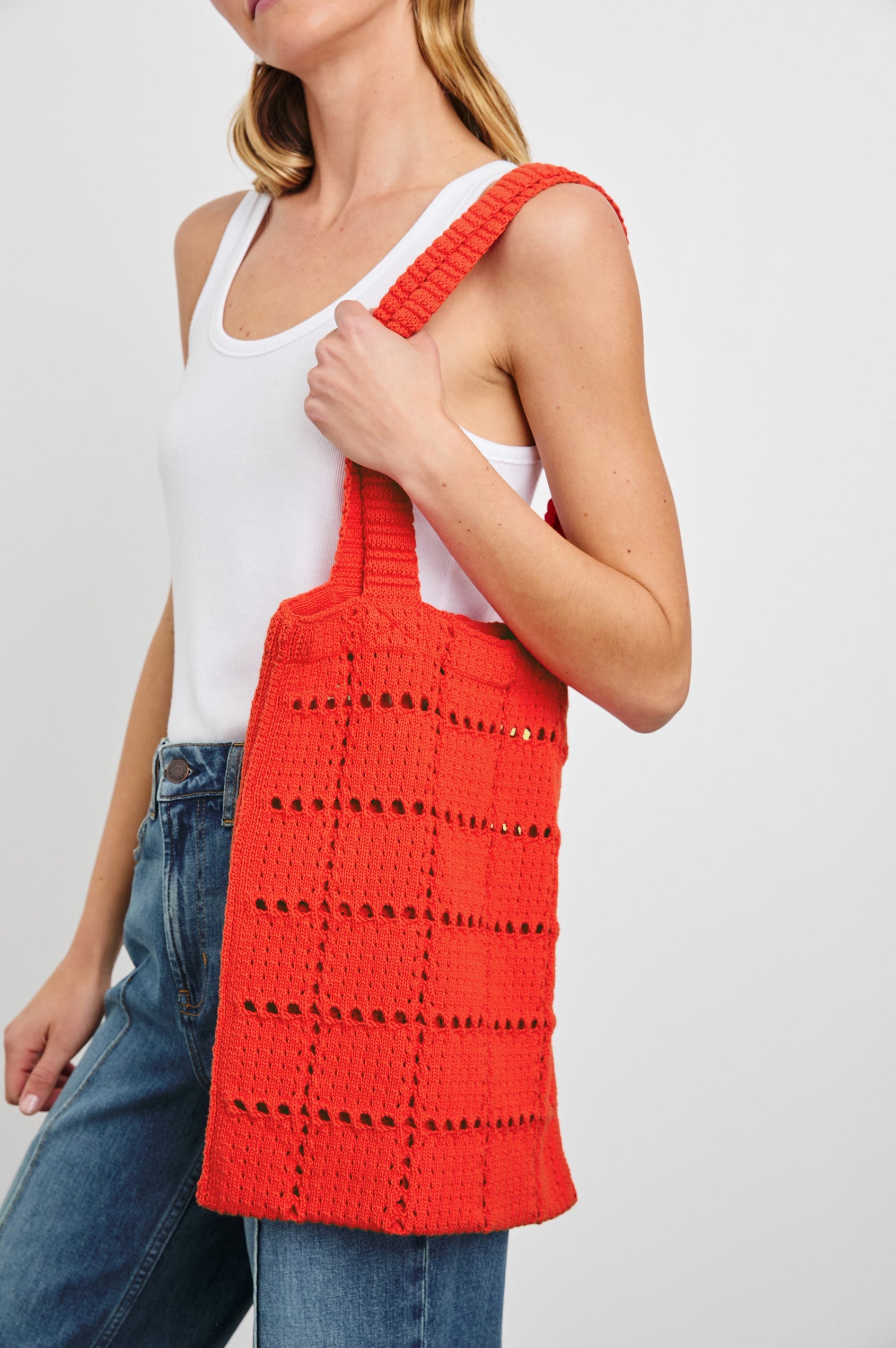 Crochet Rectangular Tote with Patchwork Grid Drop stiches in Cherry Colorway - Side View Featured on Model