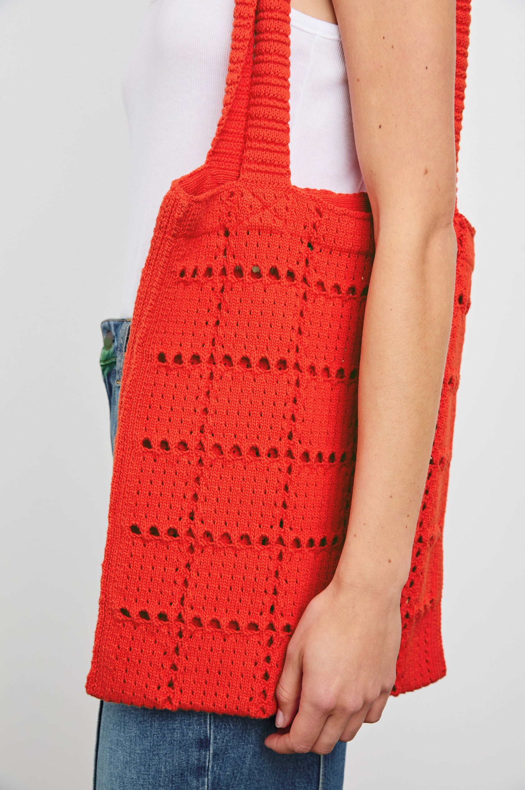 Crochet Rectangular Tote with Patchwork Grid Drop stiches in Cherry Colorway - Side View Featured on Model