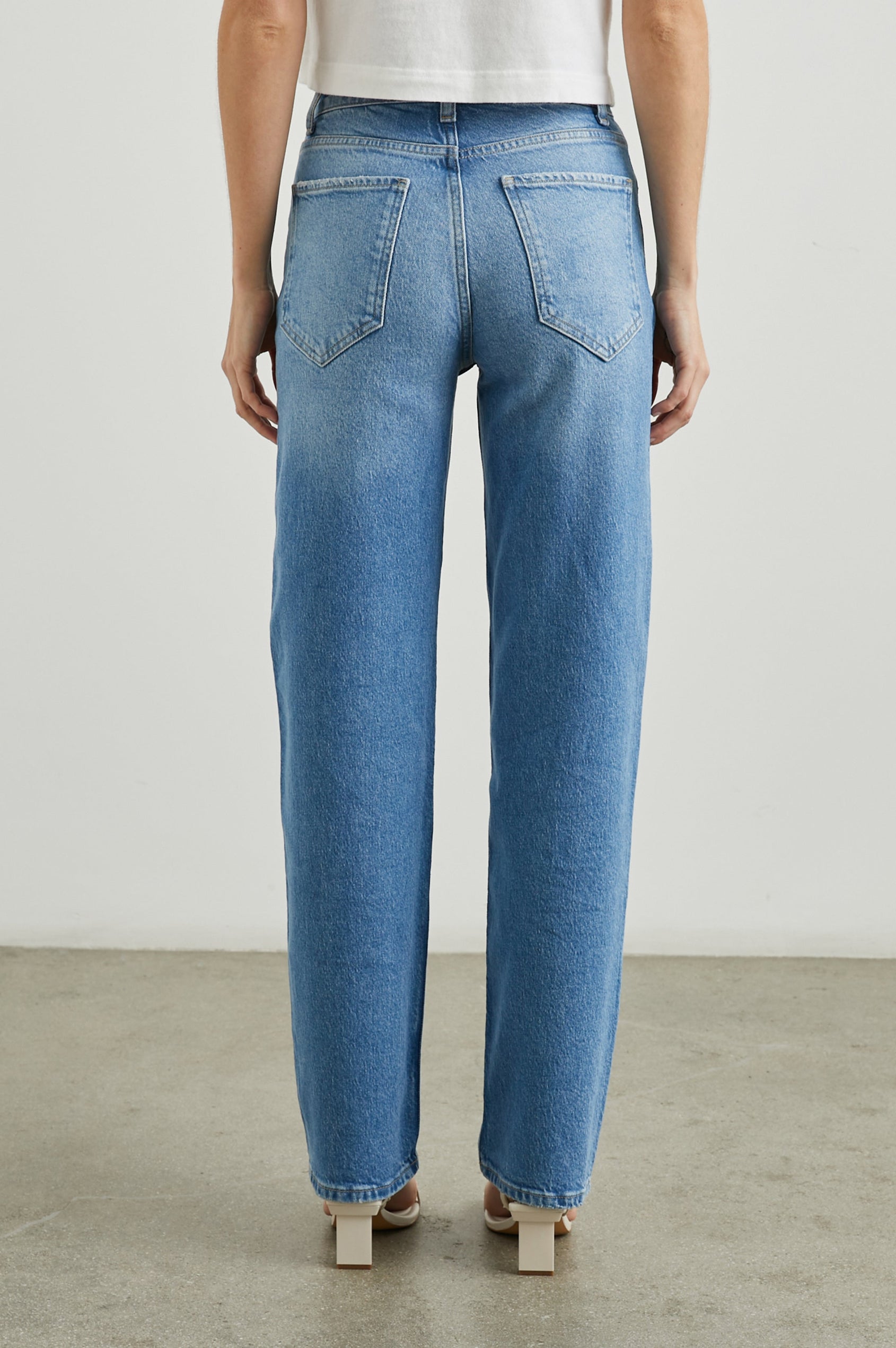 Topanga Straight Jeans with Belt Loops, Two Front Pockets plus a Coin Pocket and Two Back Patch Pockets in Baja Blue Colorway - Back View Featured on Model