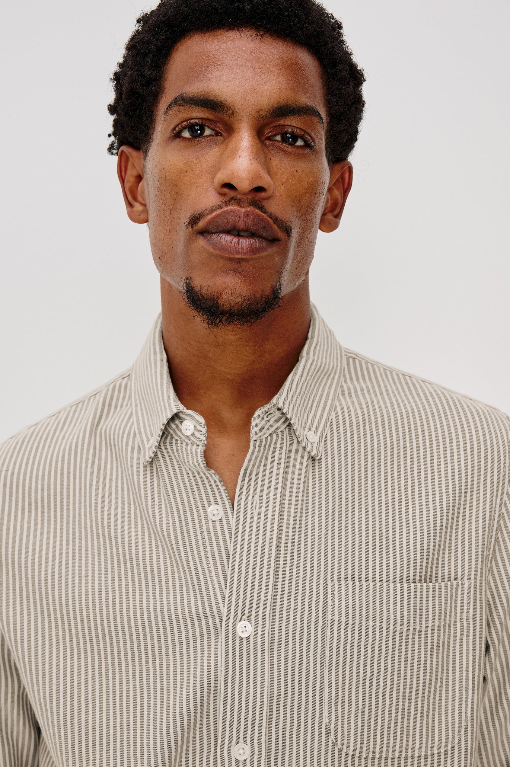 Vance button front collared shirt with long sleeves, collard stand buttons and a single chest pocket in Cedar Oat Stripe colorway. Front detail view shown on model.
