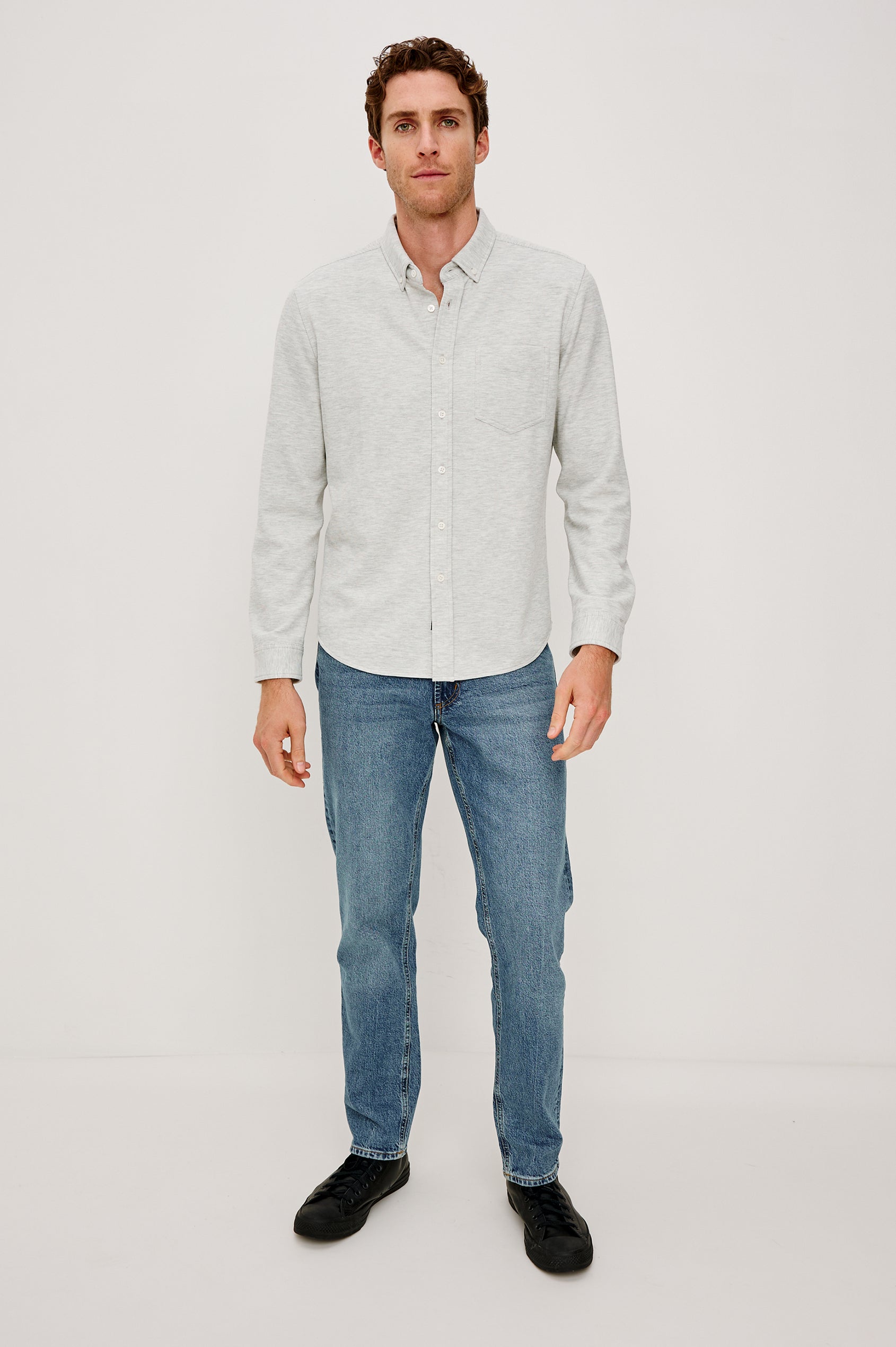 Vincent is a collared long sleeve button front shirt with a chest pocket in Heather Grey colorway. Front full body view featured on model.