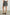 Addison Mini Skirt with a Smocked Waist and a Shorter Over Layer in Ebony Texture Colorway, a Black and White Pattern - Back View Featured on Model