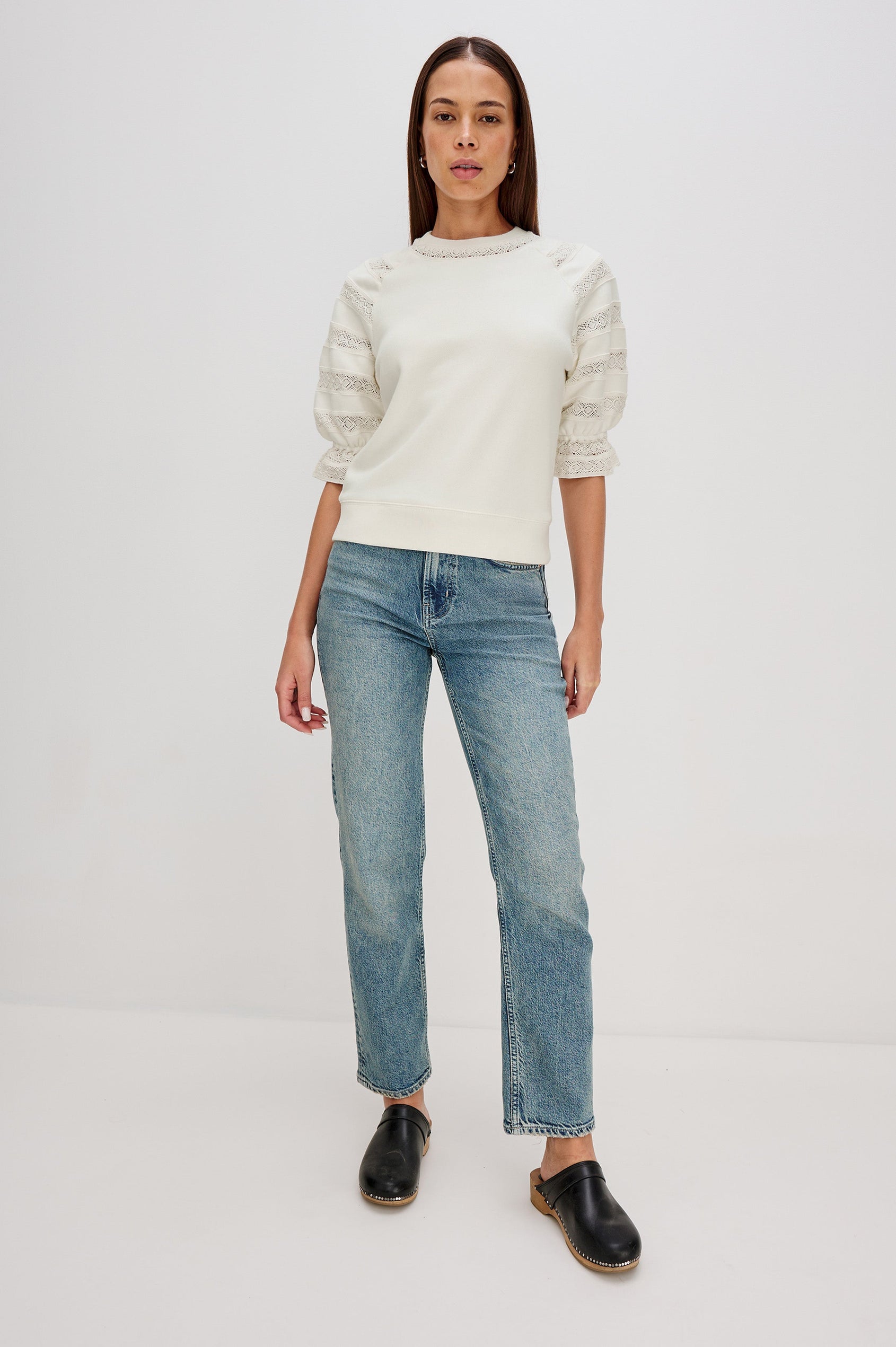 The Aggy is a raglan sleeve crew neck knit top, the sleeves are elbow length with an elastic lace cuff, there is lace inserts on sleeves and neck opening with a ribbed hem in Ivory colorway. Front Full Body View Featured on Model.