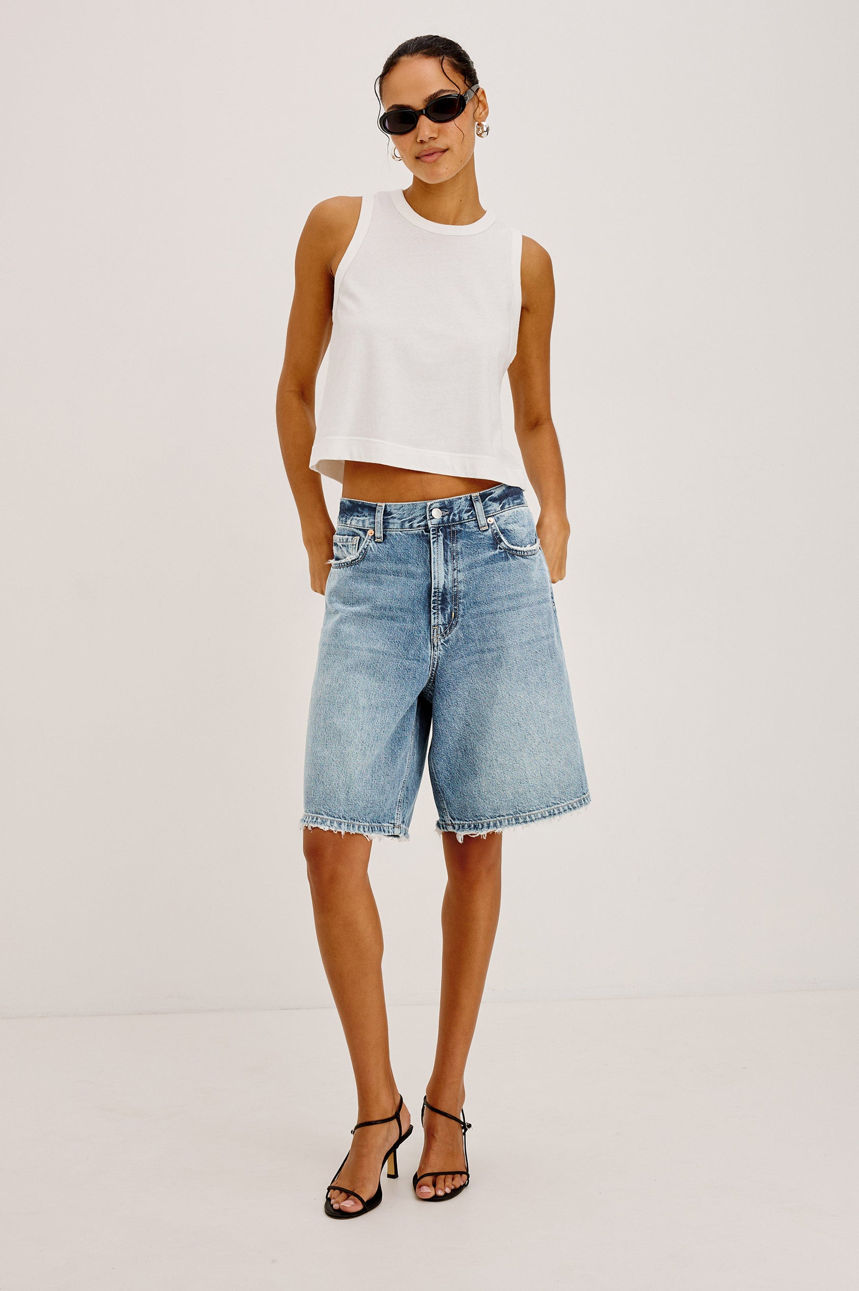Agoura Short in Rigid Denim With Wide Leg, Relaxed, Low-Slung Fit, Distressed Detailing, Zip Fly, Belt Loops, and 5-Pockets in Authentic Stone Colorway - Full Body Front View Featured on Model