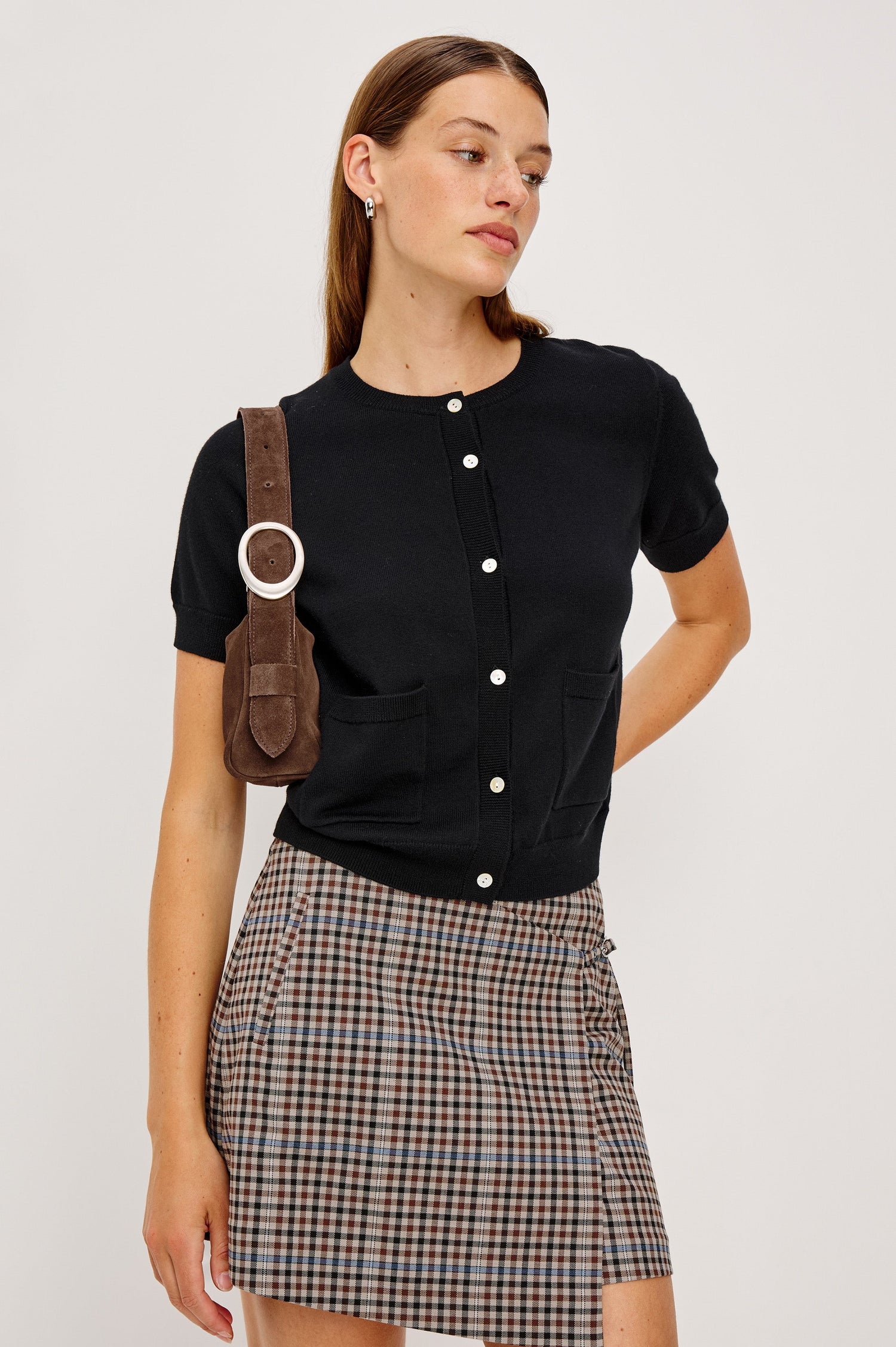 Aisley, a short-sleeve cotton-cashmere sweater with a semi-fitted silhouette. The sweater features a round neckline and is accented with a row of elegant pearl buttons down the front. Front View on Model