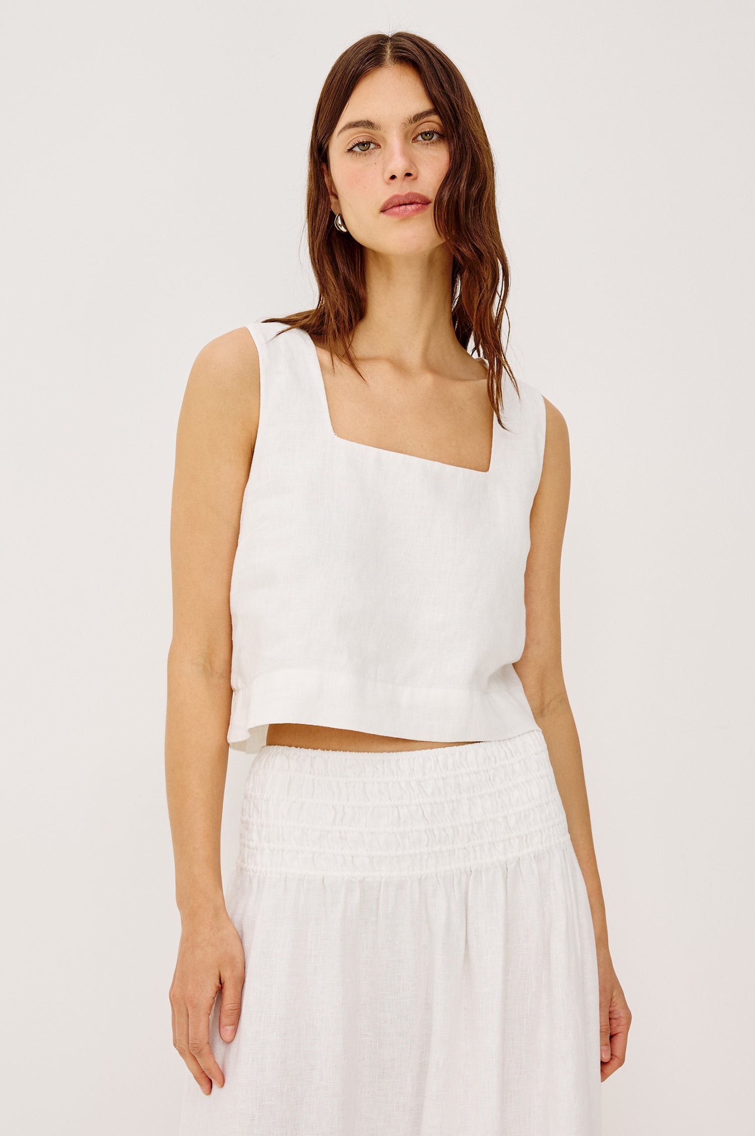 Akira Sleeveless Crop Top with Square Neckline and Wide Shoulder Straps in white Colorway - Front View Featured on Model
