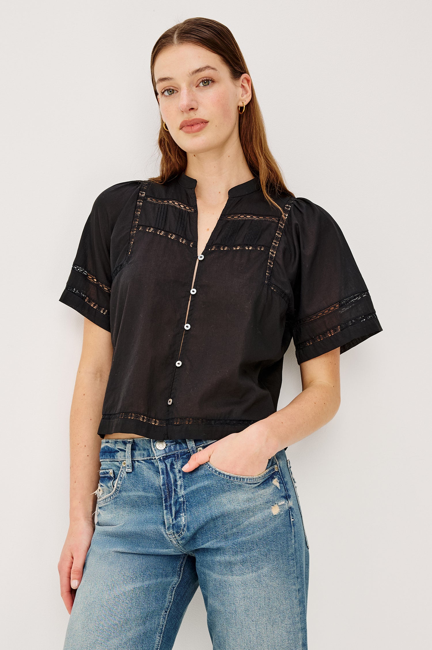 Alanis Shirt in Lightweight Cotton With Split Band V-Neckline, Front Button-and-Loop Closures, Lattice Embroidery, and Short Puff Sleeves in Black Colorway - Upper Body Front View Featured on Model