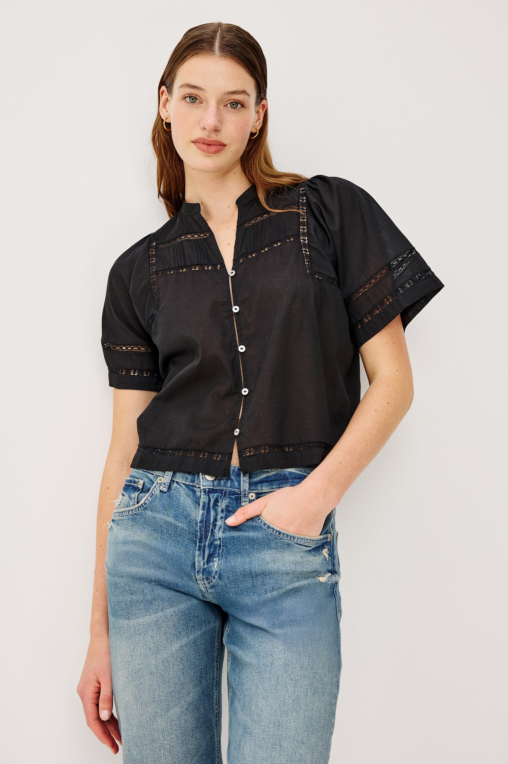 Alanis Shirt in Lightweight Cotton With Split Band V-Neckline, Front Button-and-Loop Closures, Lattice Embroidery, and Short Puff Sleeves in Black Colorway - Upper Body Front View Featured on Model