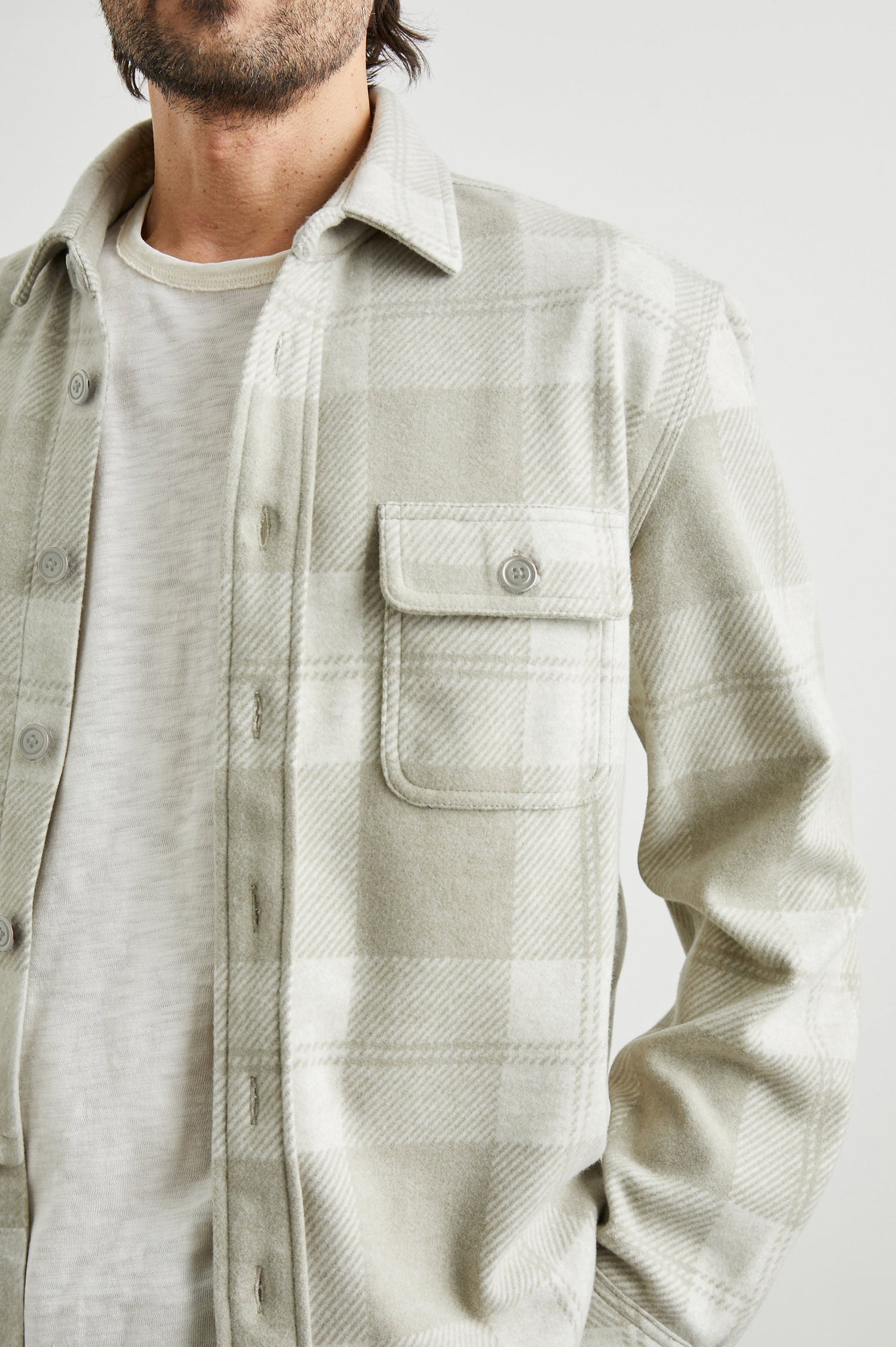 Alder Long-Sleeve Button up with Two Buttoned Chest Flap Pockets in Fawn Cream Colorway, a plaid - Front Unbuttoned View Featured on Model