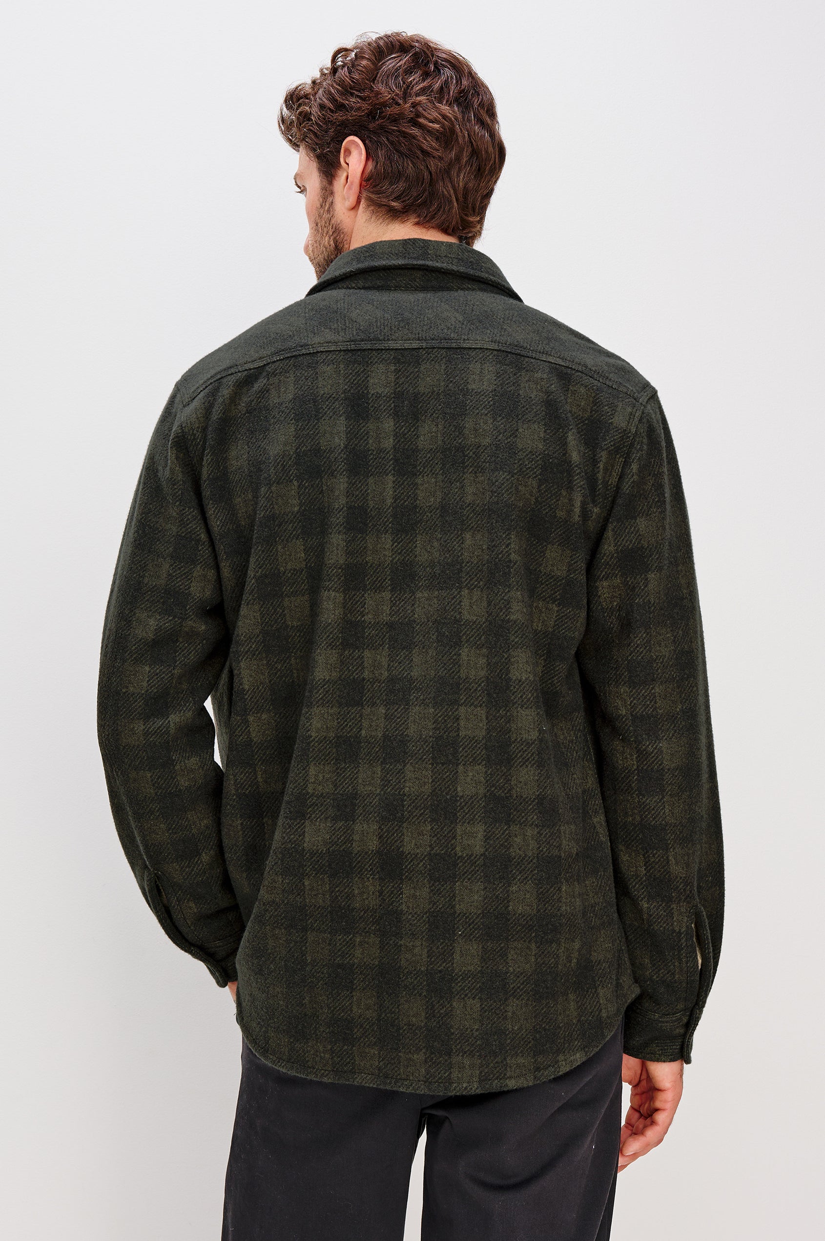 Alder Long-Sleeve Button up with Two Buttoned Chest Flap Pockets in Onyx Surplus Colorway, a Green and Black plaid. Back View Featured on Model