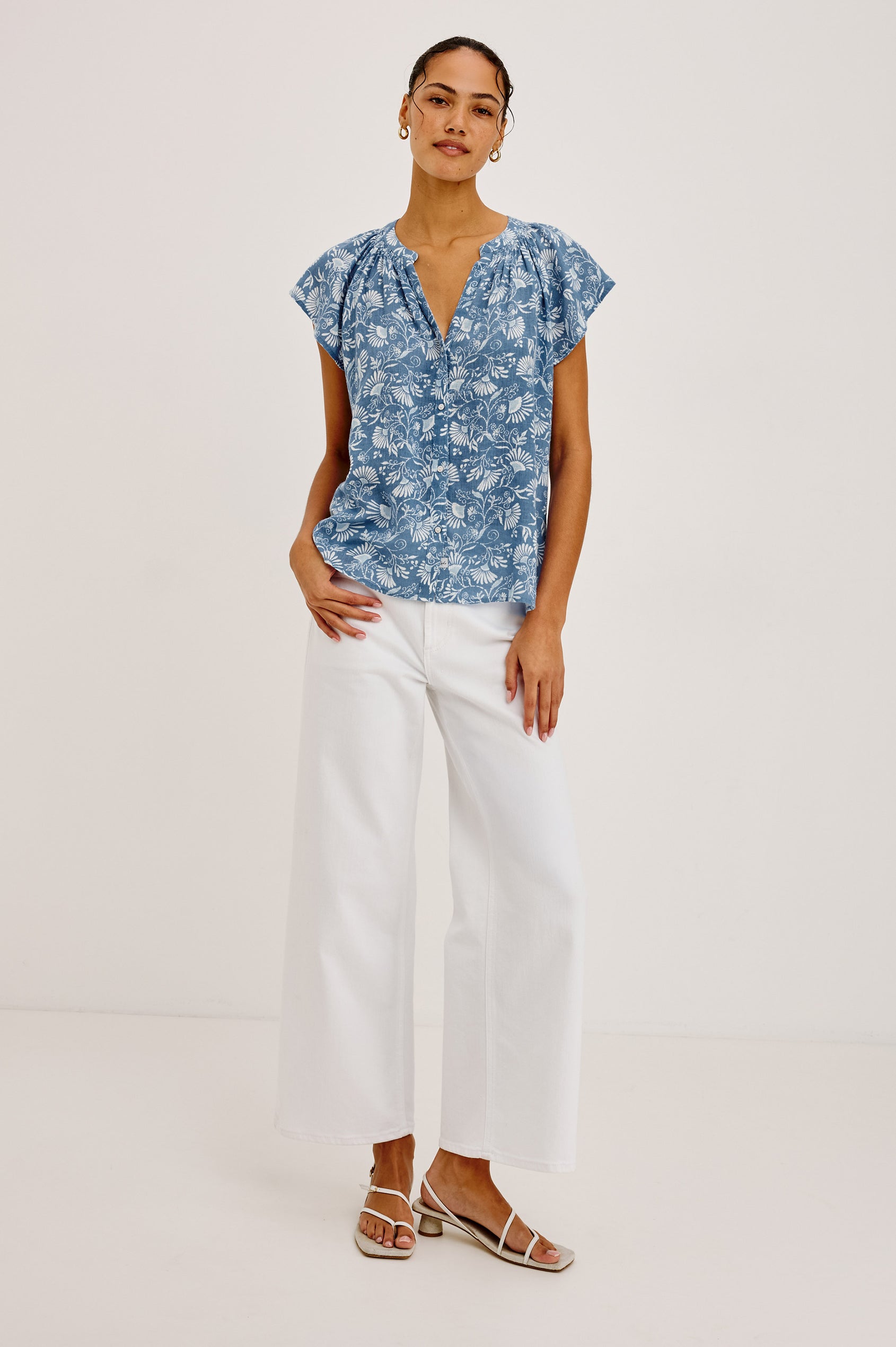 Alena Top in Cotton Gauze With Relaxed Fit, Smocked Split Neckline, Cap Sleeves, and Front Button Placket in Blue Cassia Colorway - Full Body Front View Featured on Model