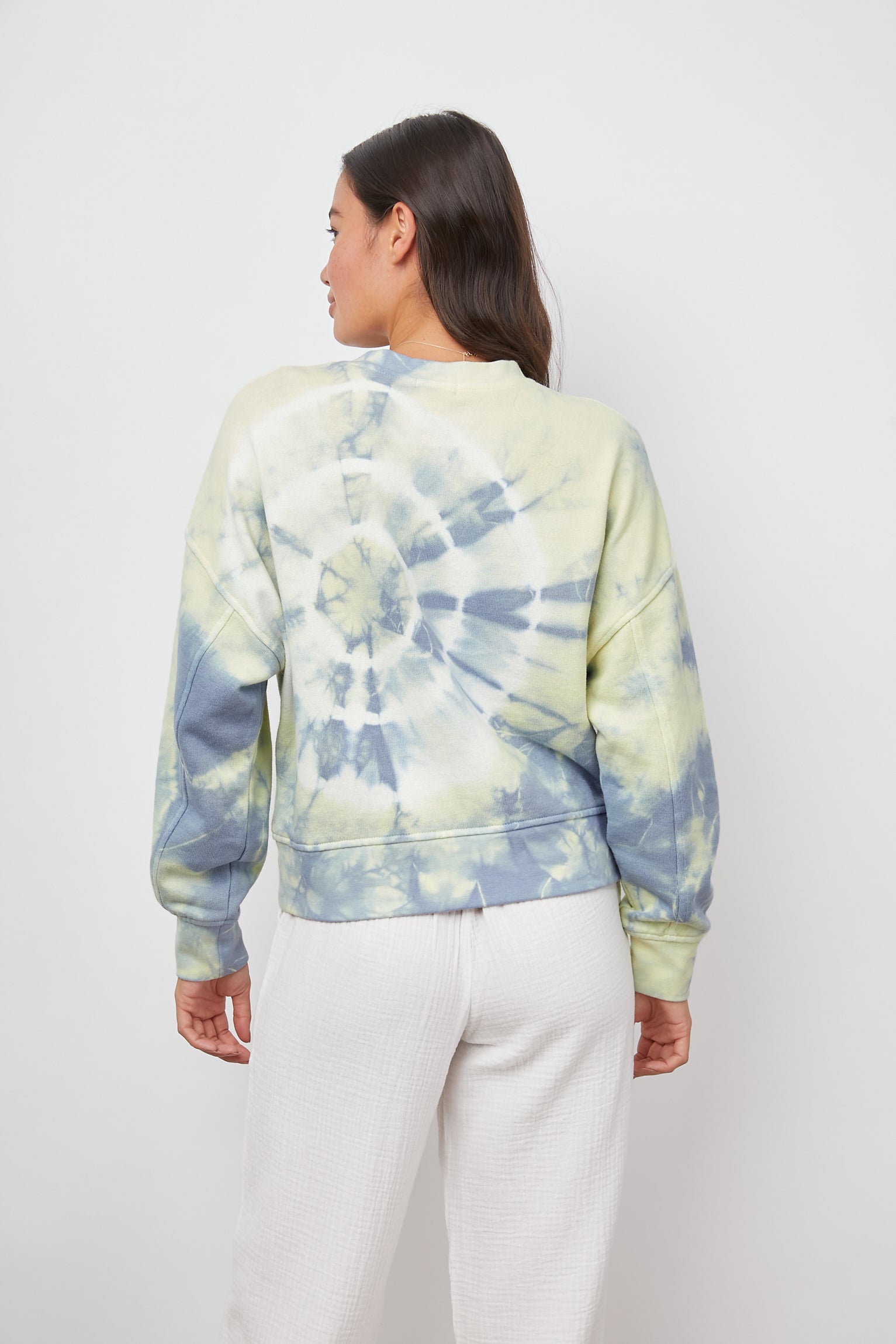 Alice & Jane Set with a Sweatshirt and Shorts with Two Front Pockets and One Back Patch Pocket in Laguna Colorway, a Tie Die in Blue, Yellow and White - Back Sweatshirt View Featured on Model 