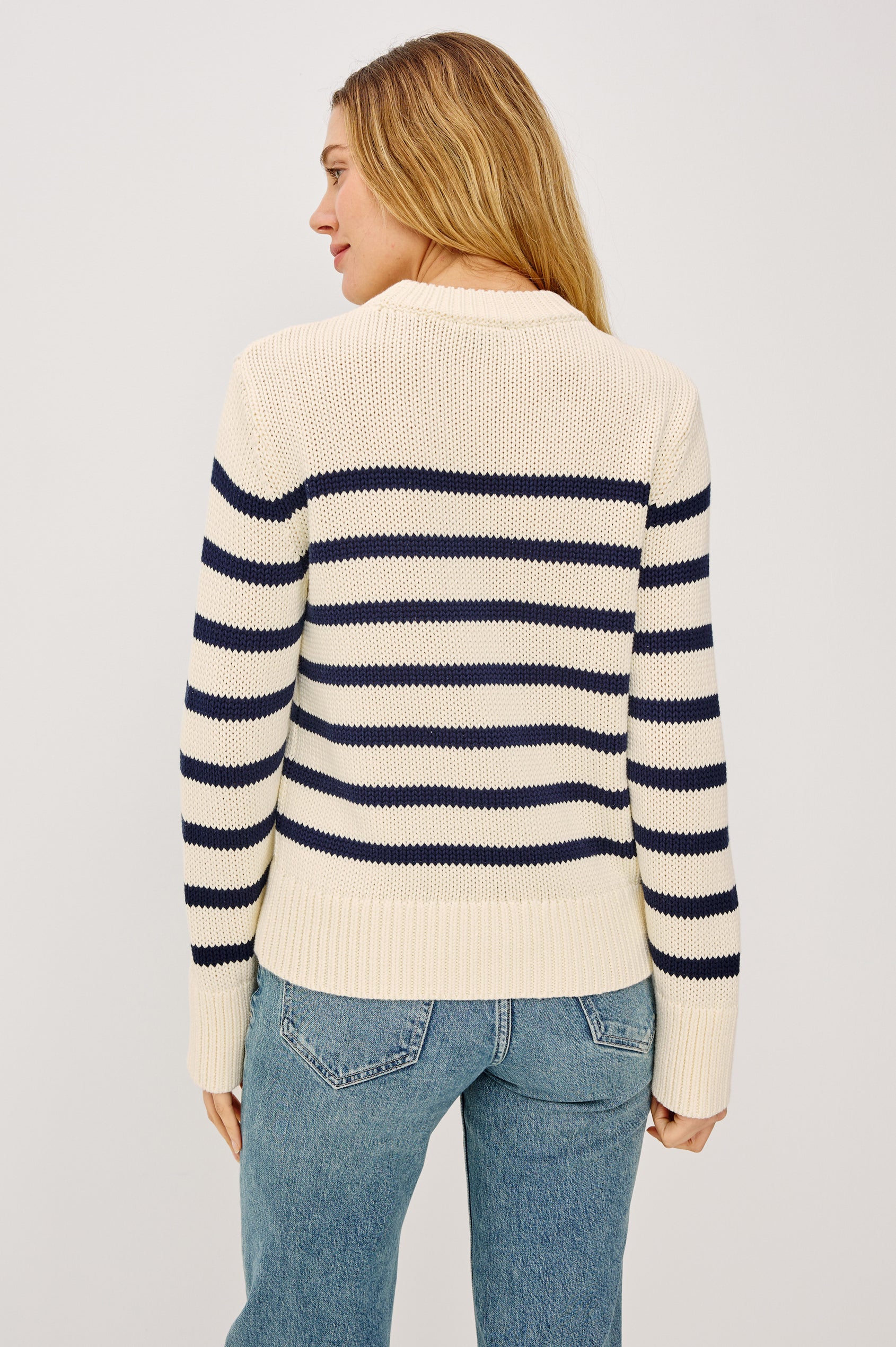 Alise Sweater in 100% Cotton Yarn With Ribbed Collar and Cuffs, Crew Neckline, and Long Sleeves in Ivory Navy Stripe Colorway - Upper Body Back View Featured on Model