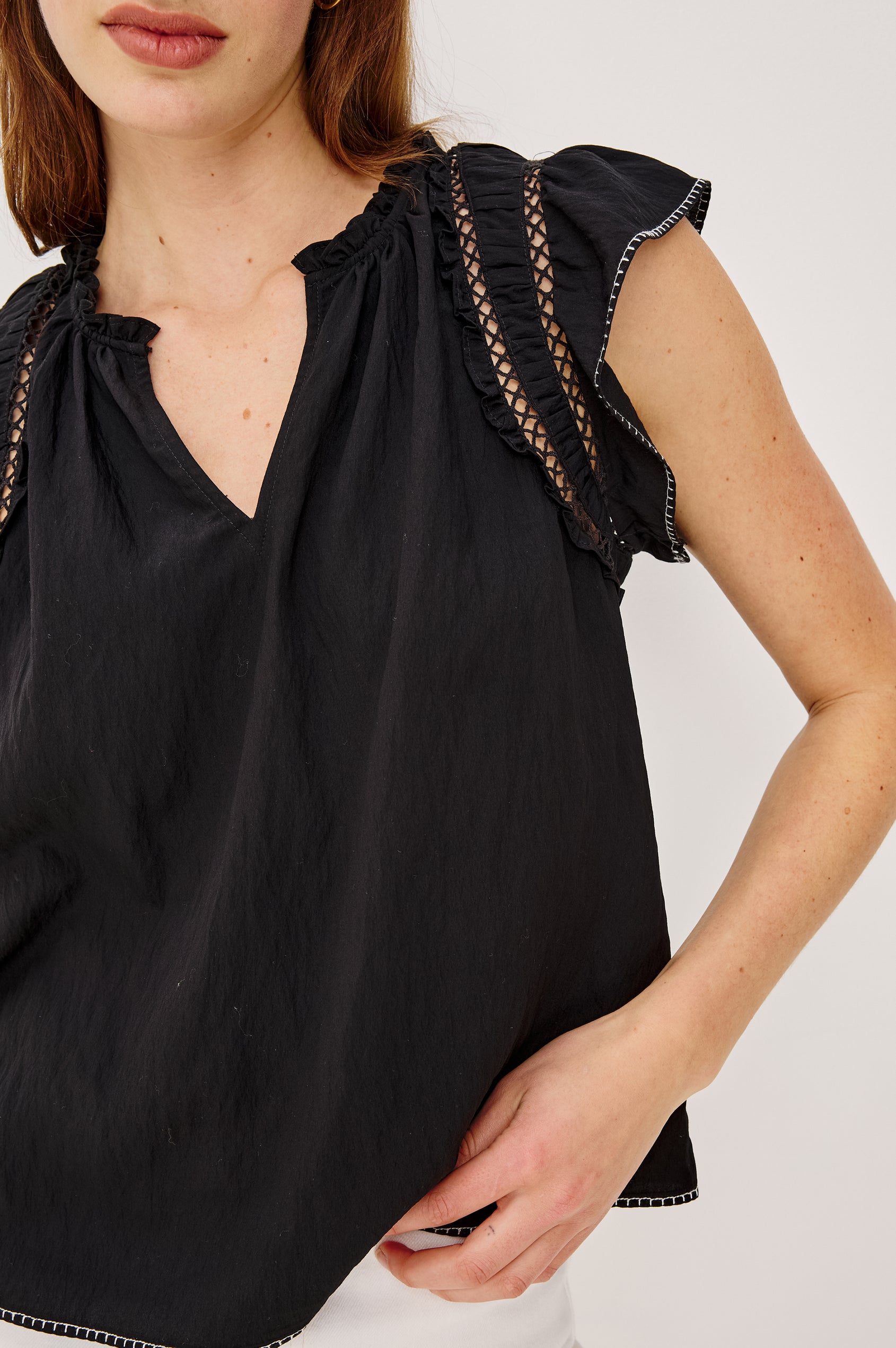 Allea Top in Poplin With Relaxed Fit Split V-Neck. Flutter Sleeves With Contrast Stitcing and Lattice Cutwork in Black Colorway - Upper Body Front View Featured on Model