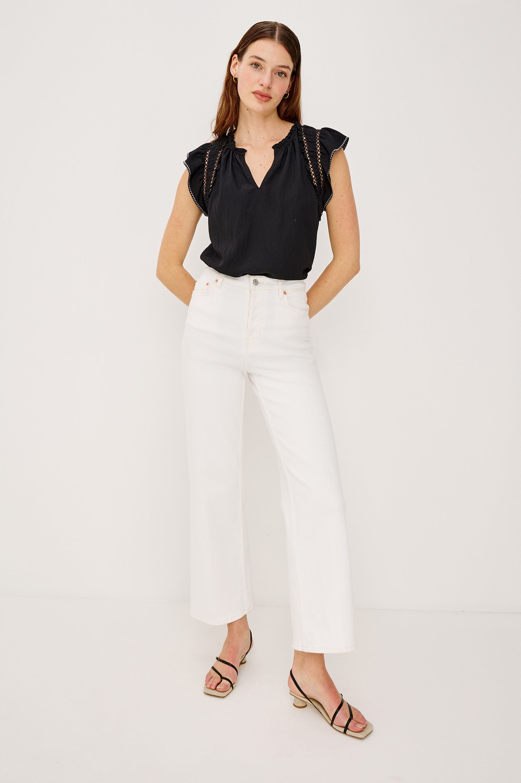Allea Top in Poplin With Relaxed Fit Split V-Neck. Flutter Sleeves With Contrast Stitcing and Lattice Cutwork in Black Colorway - Full Body Front View Featured on Model