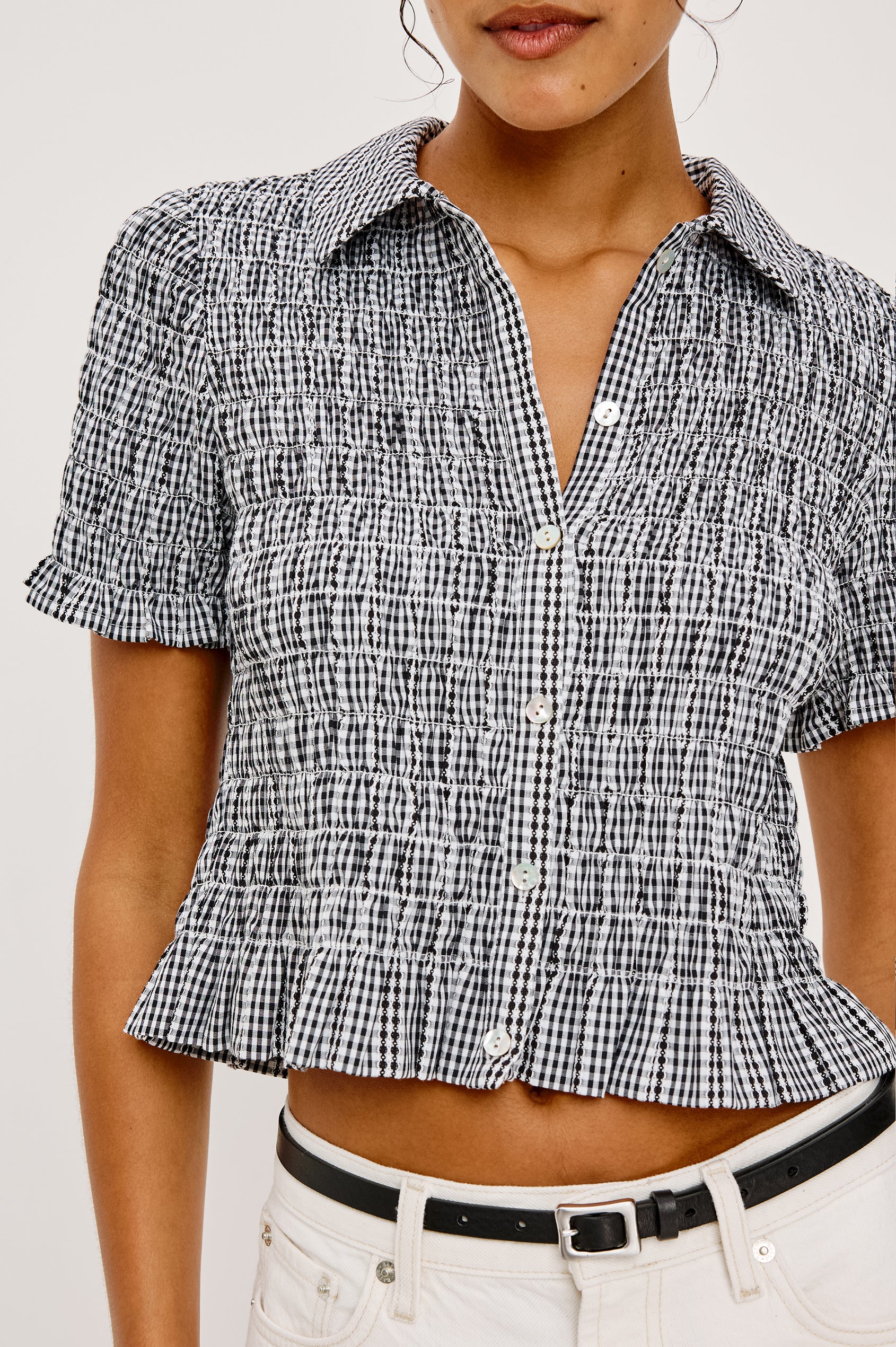 Alton Top in Cotton Poplin With Smocked Body Boxy Cropped Fit Collar Front Buttons Short Puff Sleeves and Ruffle Trim in Black Gingham Colorway - Upper Body Close Up Front View Featured on Model