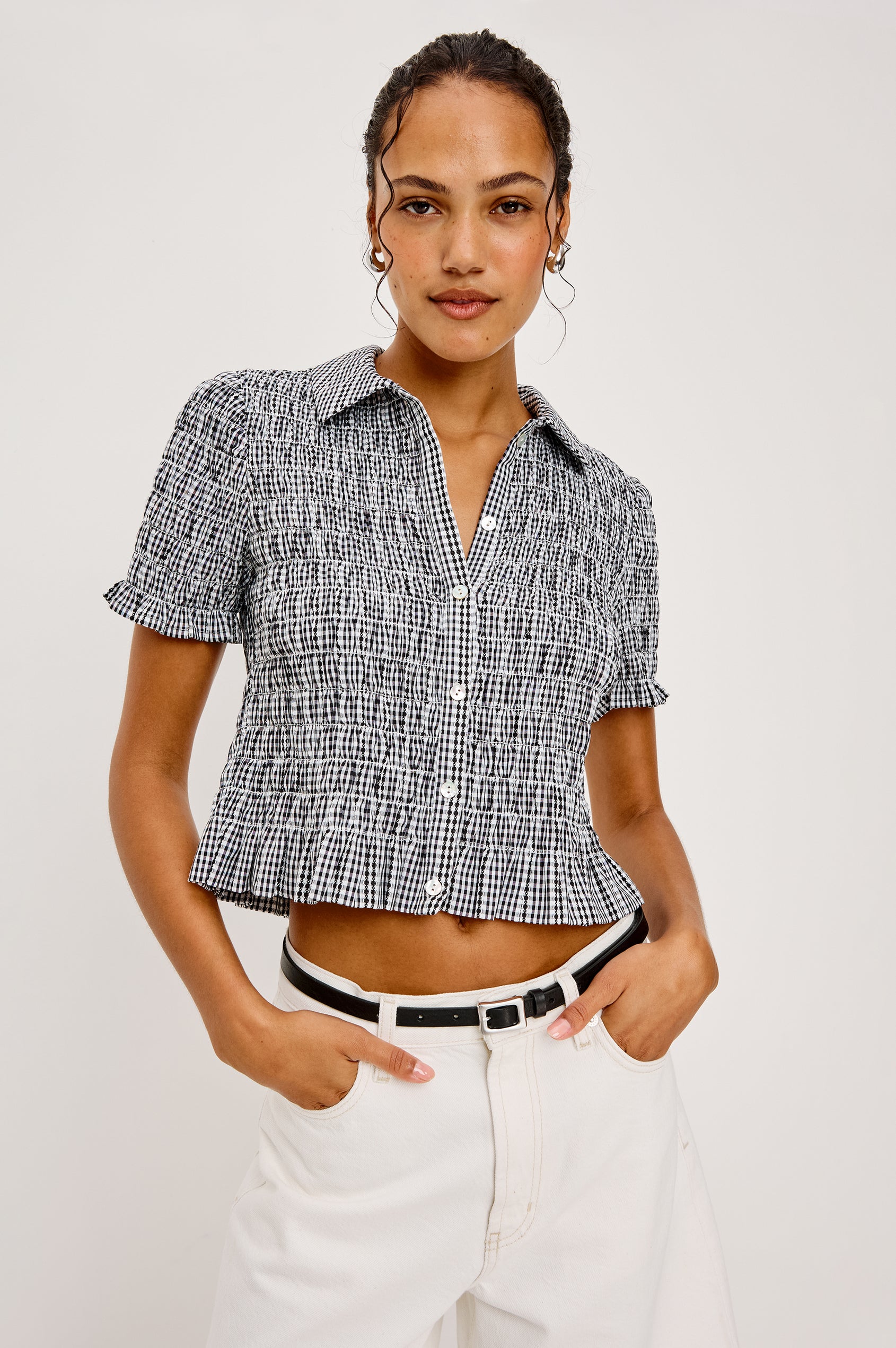 Alton Top in Cotton Poplin With Smocked Body Boxy Cropped Fit Collar Front Buttons Short Puff Sleeves and Ruffle Trim in Black Gingham Colorway - Upper Body Front View Featured on Model