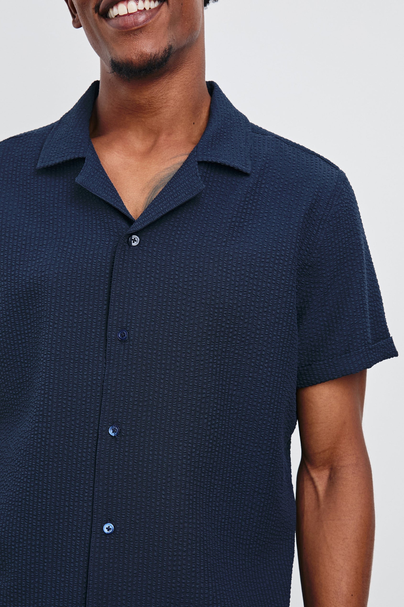 Amalfi Short-Sleeve Button Up in Navy Seersucker Colorway - Front View Featured on Model