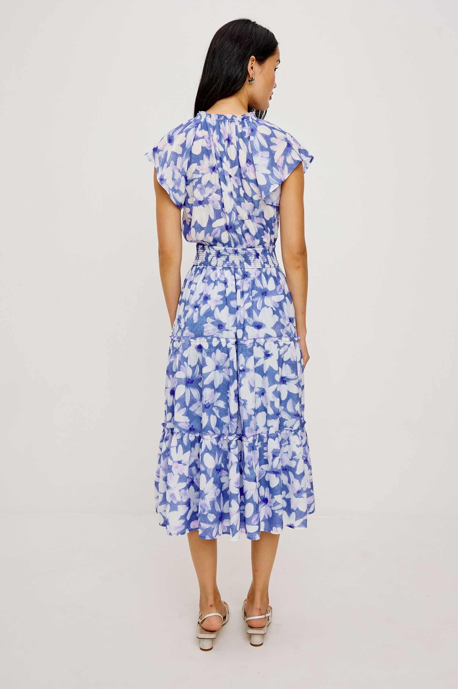 Amellia Midi Dress in Chiffon With Ruffled Split V-Neckline Flutter Sleeves a Smocked Waist and Tiered A-Line Skirt in Blue Ameranth Colorway - Full Body Back View Featured on Model