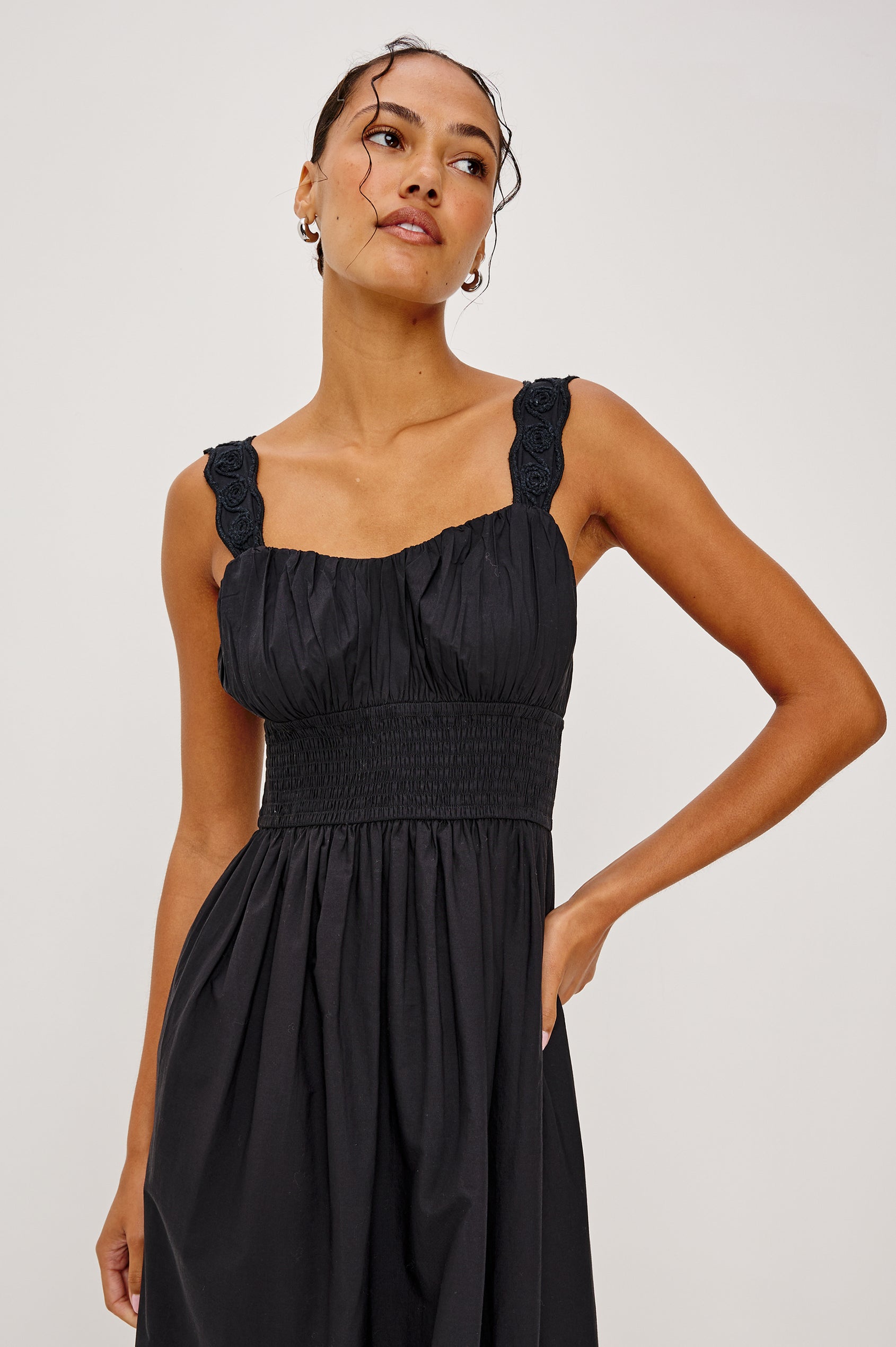 Anadia Maxi Dress in Poplin With Soutached Swirl Shoulder Straps, Ruched Bust, Smocked Empire Waist, and Scalloped Ladder Embroidered Hem in Black Colorway - Upper Body Front View Featured on Model