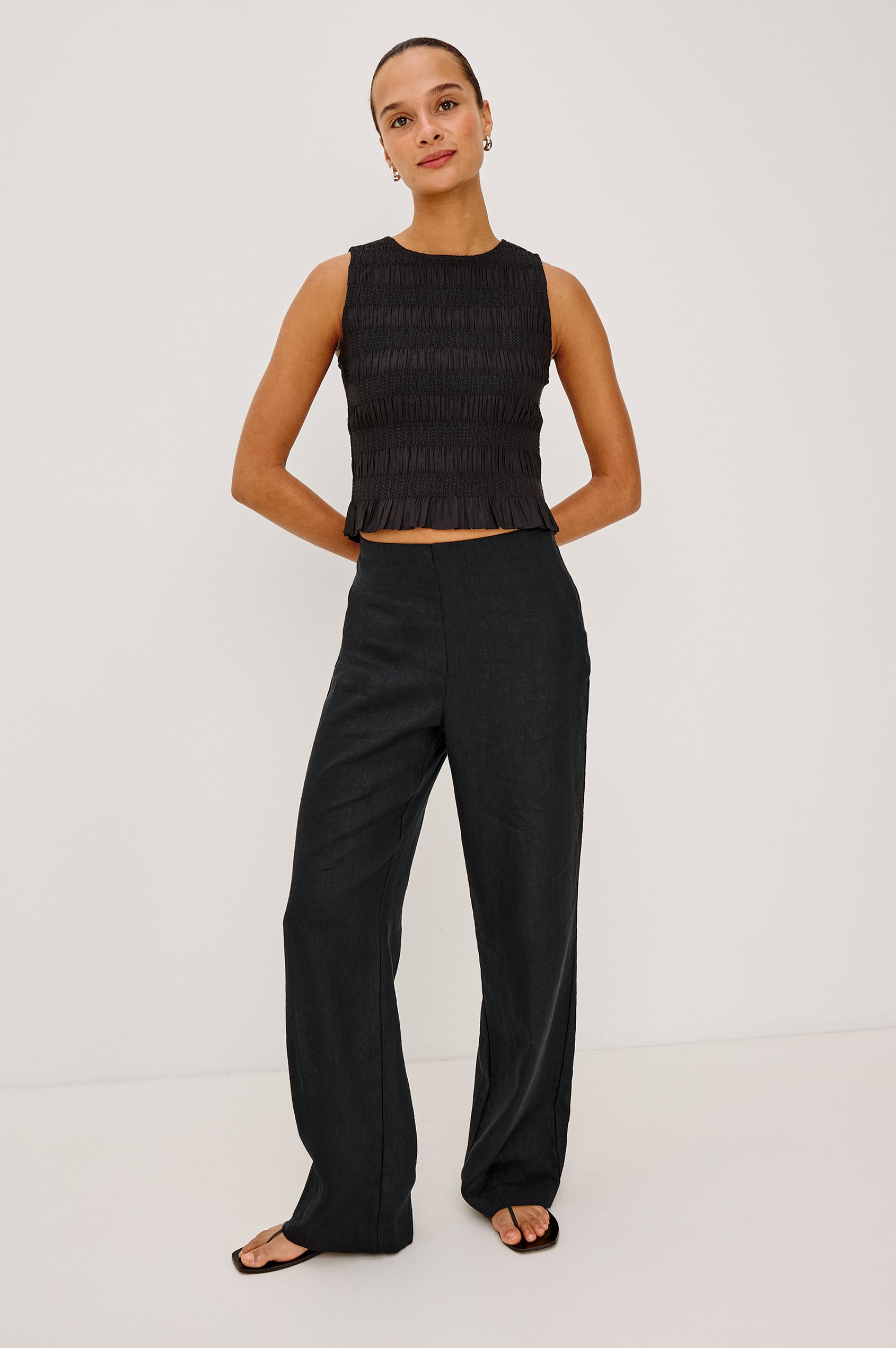 Andrine Pant in Heavy Linen With High-Waisted Fit, Straight Legs, Unlined, Side On-Seam Pockets, Side Zip Closure in Black Colorway - Full Body Front View Featured on Model