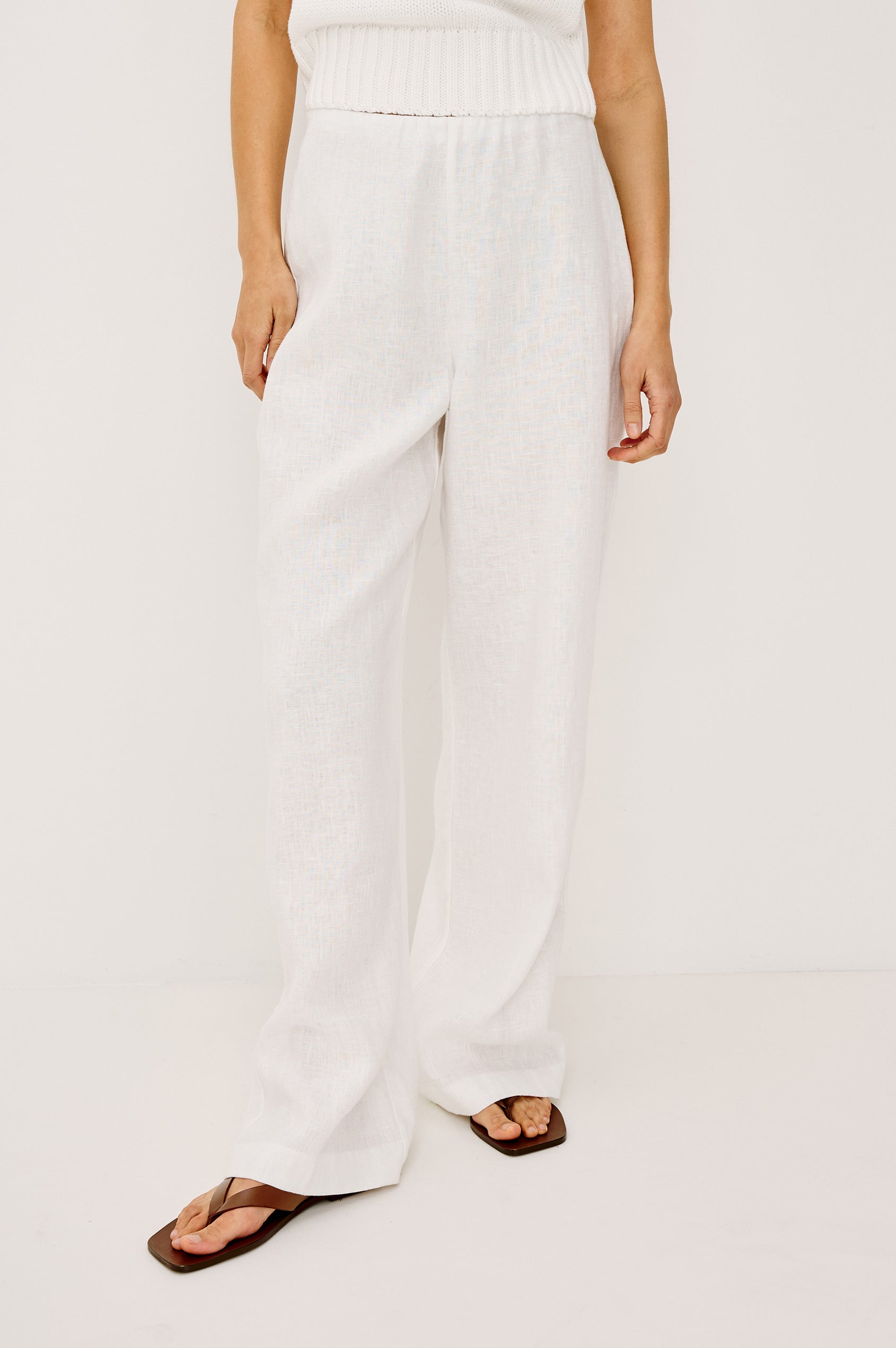 Andrine Pant in Heavy Linen With High-Waisted Fit, Straight Legs, Unlined, Side On-Seam Pockets, Side Zip Closure in White Colorway - Lower Body Front View Featured on Model