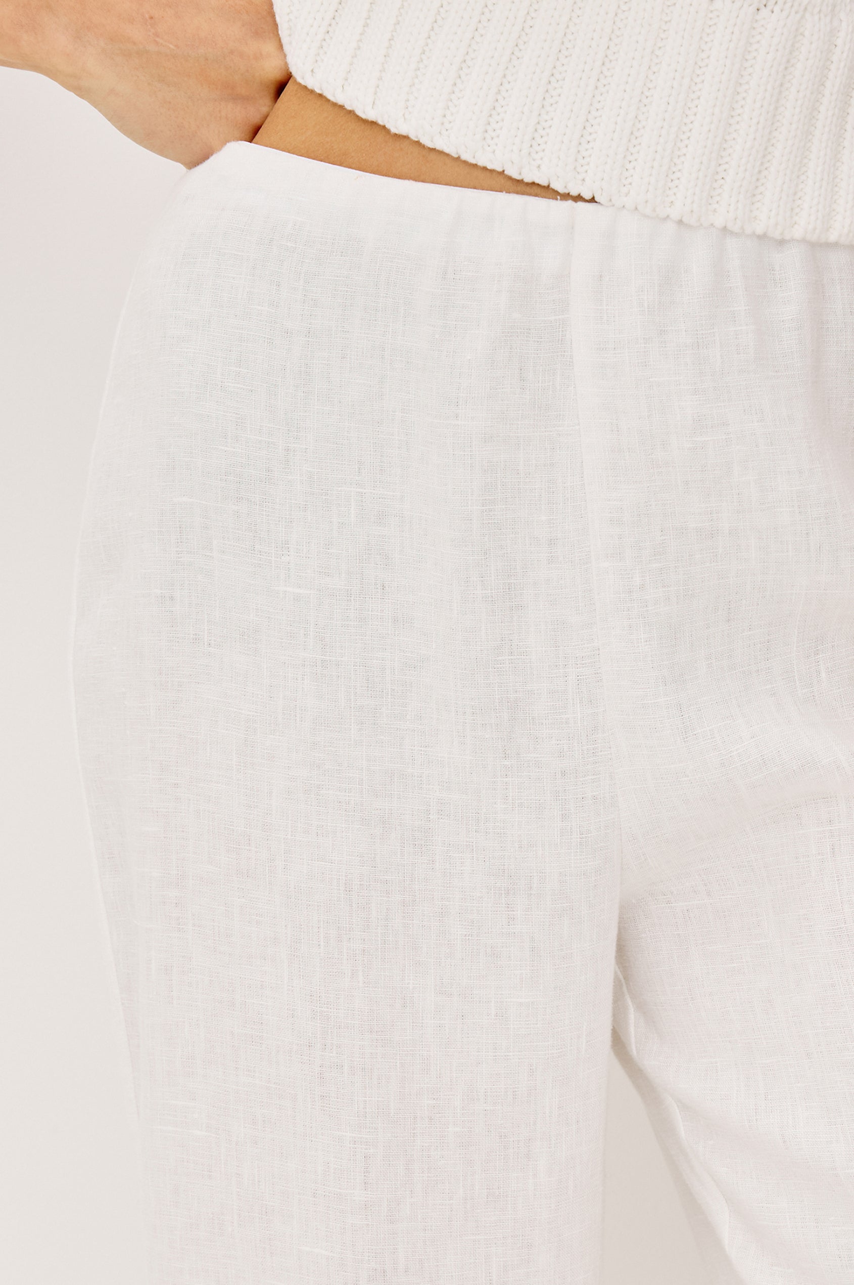 Andrine Pant in Heavy Linen With High-Waisted Fit, Straight Legs, Unlined, Side On-Seam Pockets, Side Zip Closure in White Colorway - Close Up Detail View Featured on Model