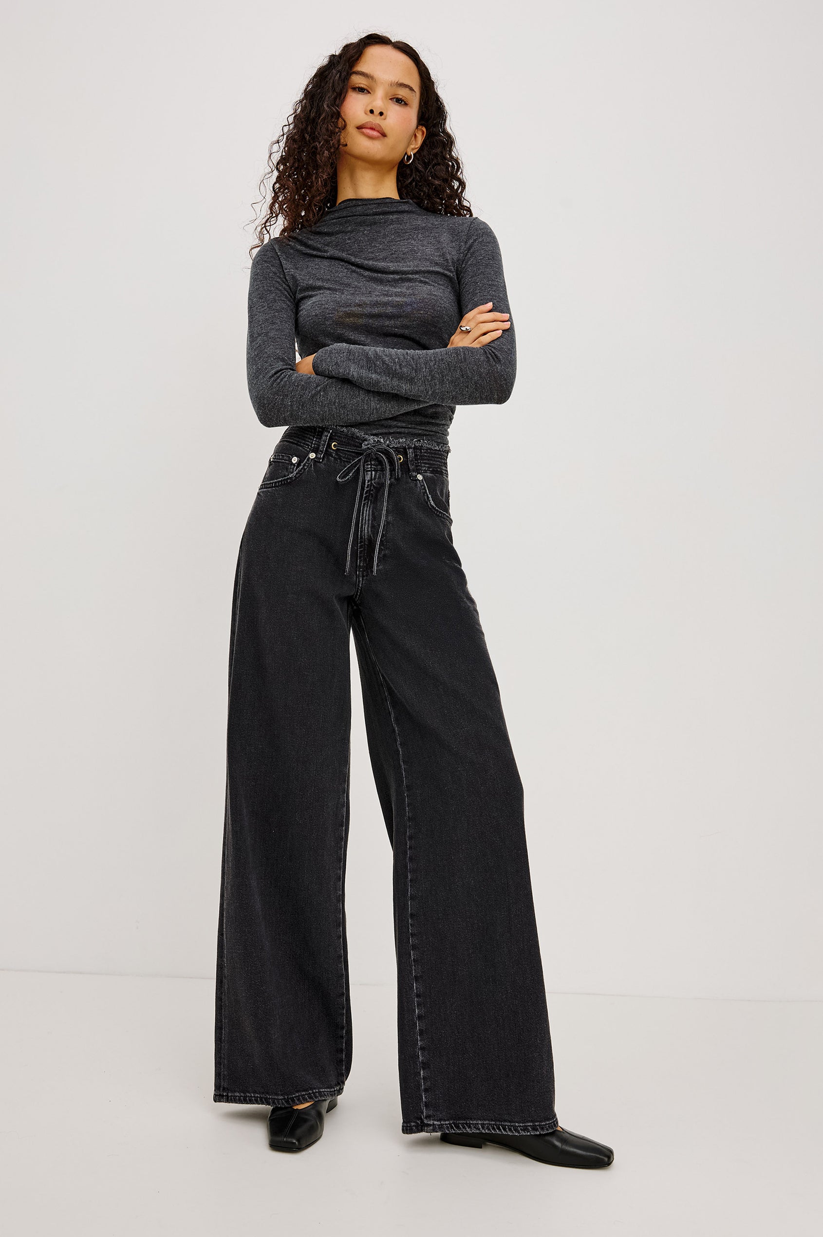 Angeleno Wide Leg in Rigid Denim With Hidden Stretch, Relaxed Mid-Rise Fit, 5-Pockets, Self-Tie Shoelace Belt, and Frayed Waistband in Ash Black Colorway - Full Body Front View Featured on Model