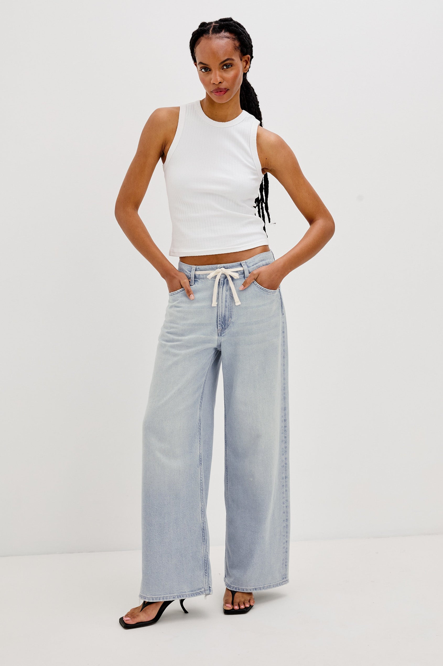 Angeleno Crop Denim Pant, Wide Leg, Five Pocket Zip Fly with a White Drawstring Tie at Waist in Light Wash Scuba Colorway. Front View Shown on Model.