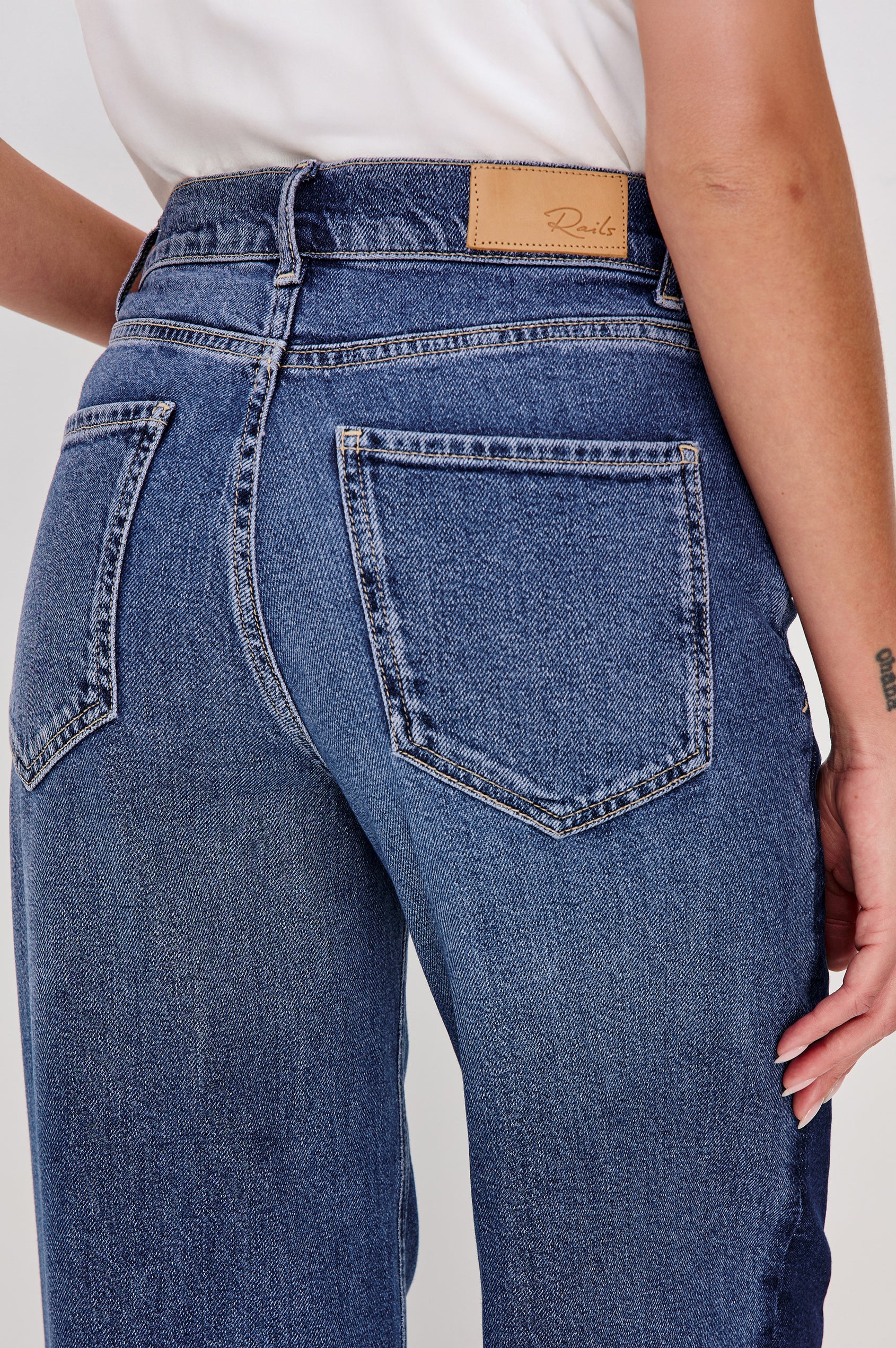 Angeleno Wide Leg Jeans With Mid-rise, Contrast Godet Inserts, Front Zip-Fly, and 5-Pocket Styling in Godet Indigo Grove Colorway - Lower Body Back Close Up VIew Featured on Model