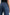 Angeleno Wide Leg Denim Pants with Belt Loops, Two Front Pockets and Two Back Patch Pockets in Pebble Blue Colorway - Back View Featured on Model