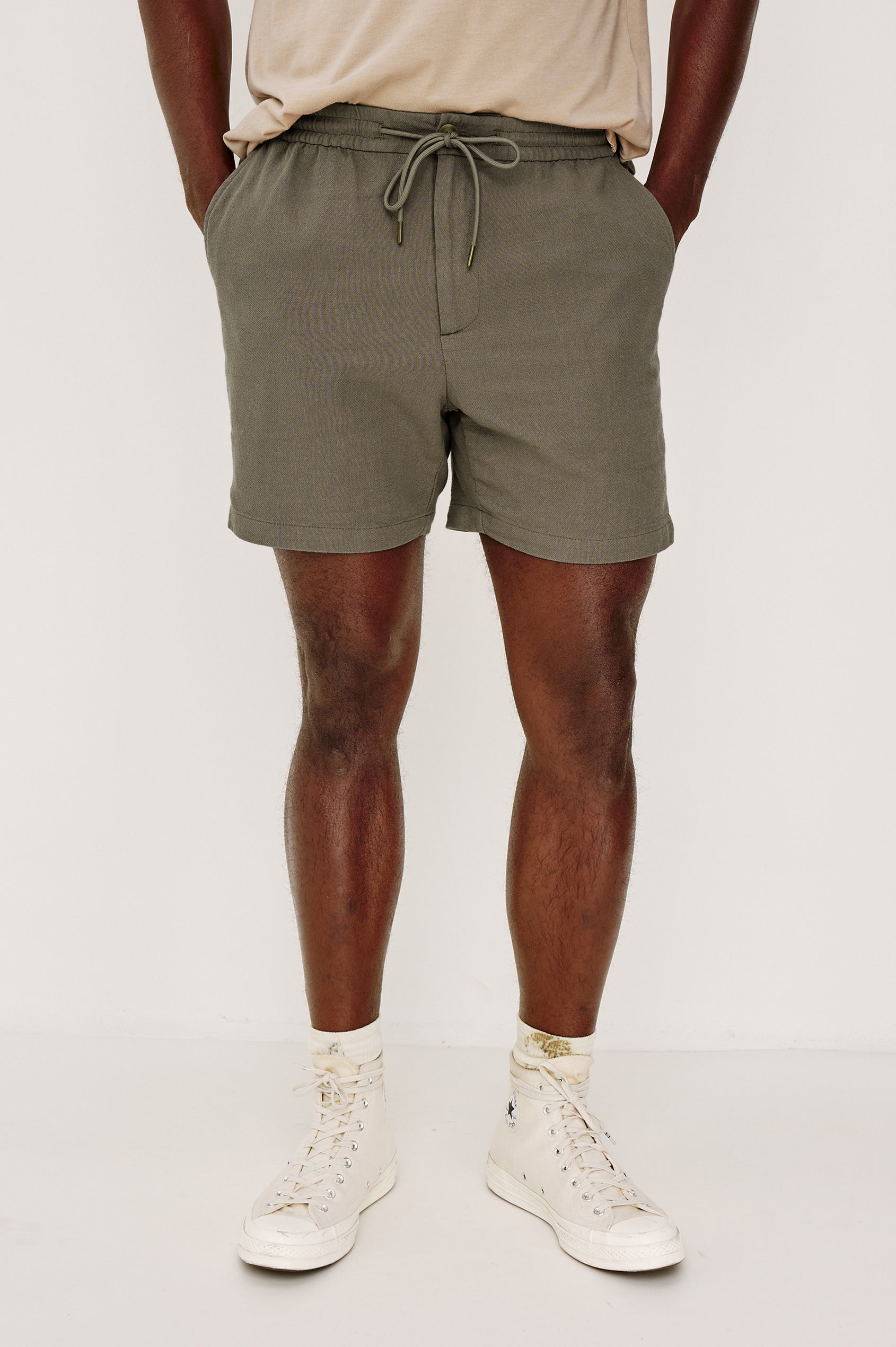 Archer Short in Unlined Cotton Linen With Relaxed Fit, Adjustable Waist Drawstring Ties, Side Pockts, and 6-Inch Inseam in Fallen Rock Colorway - Lower Body Front View Featured on Model