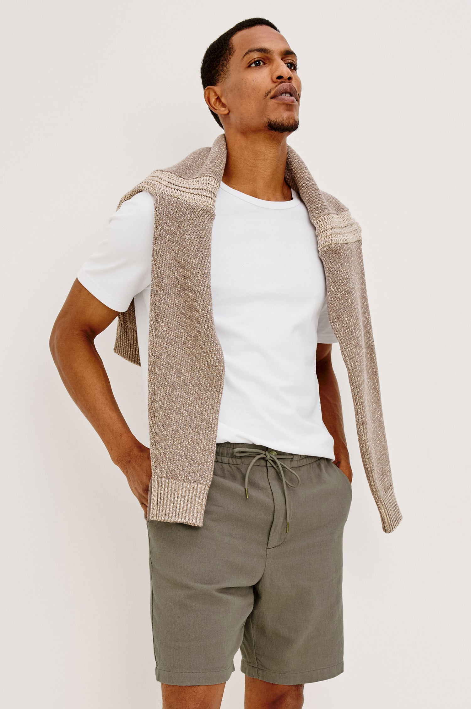 Archer Short in Unlined Cotton Linen With Relaxed Fit, Adjustable Waist Drawstring Ties, Side Pockts, and 8.5-Inch Inseam in Medium Wash Indigo Colorway - Lower Body Front View Featured on Model