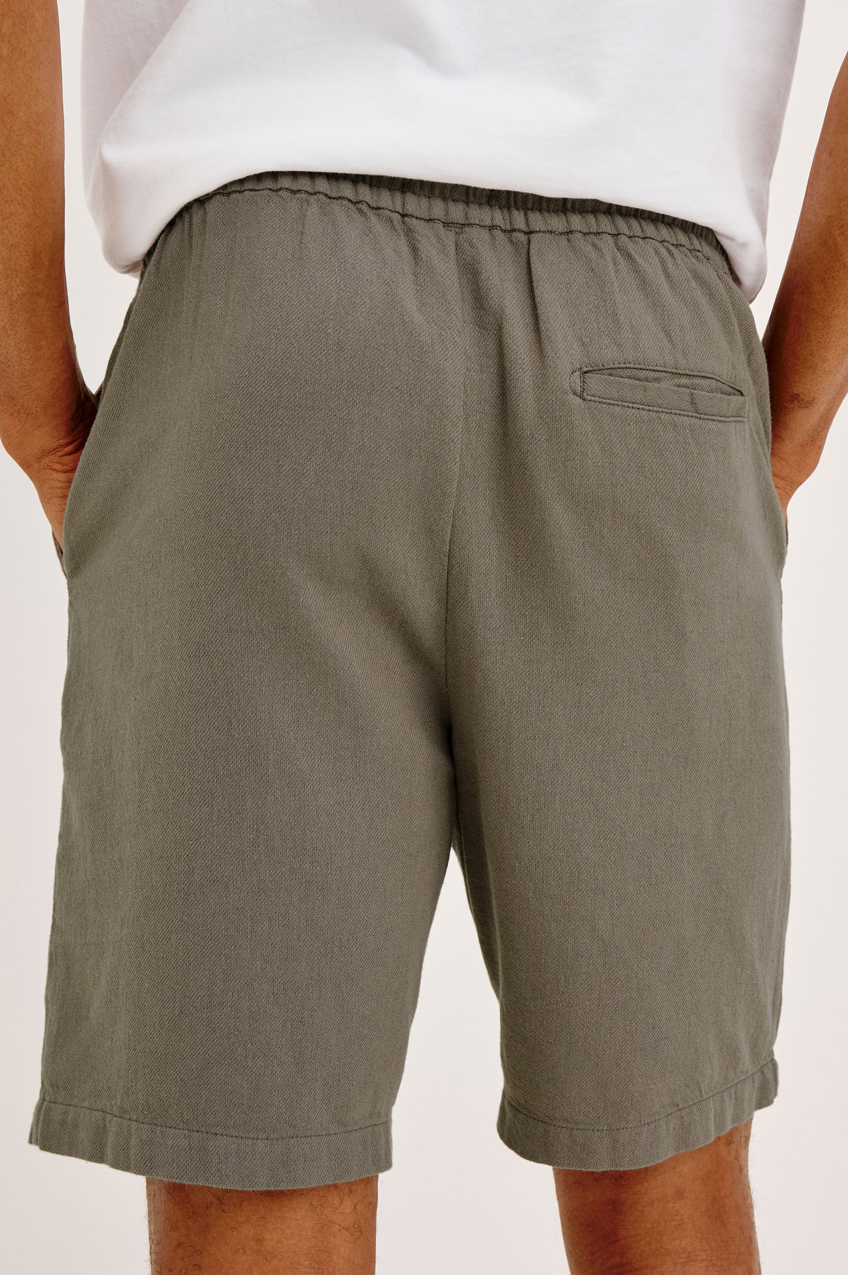 Archer Short in Unlined Cotton Linen With Relaxed Fit, Adjustable Waist Drawstring Ties, Side Pockts, and 6-Inch Inseam in Fallen Rock Colorway - Lower Body Back View Featured on Model