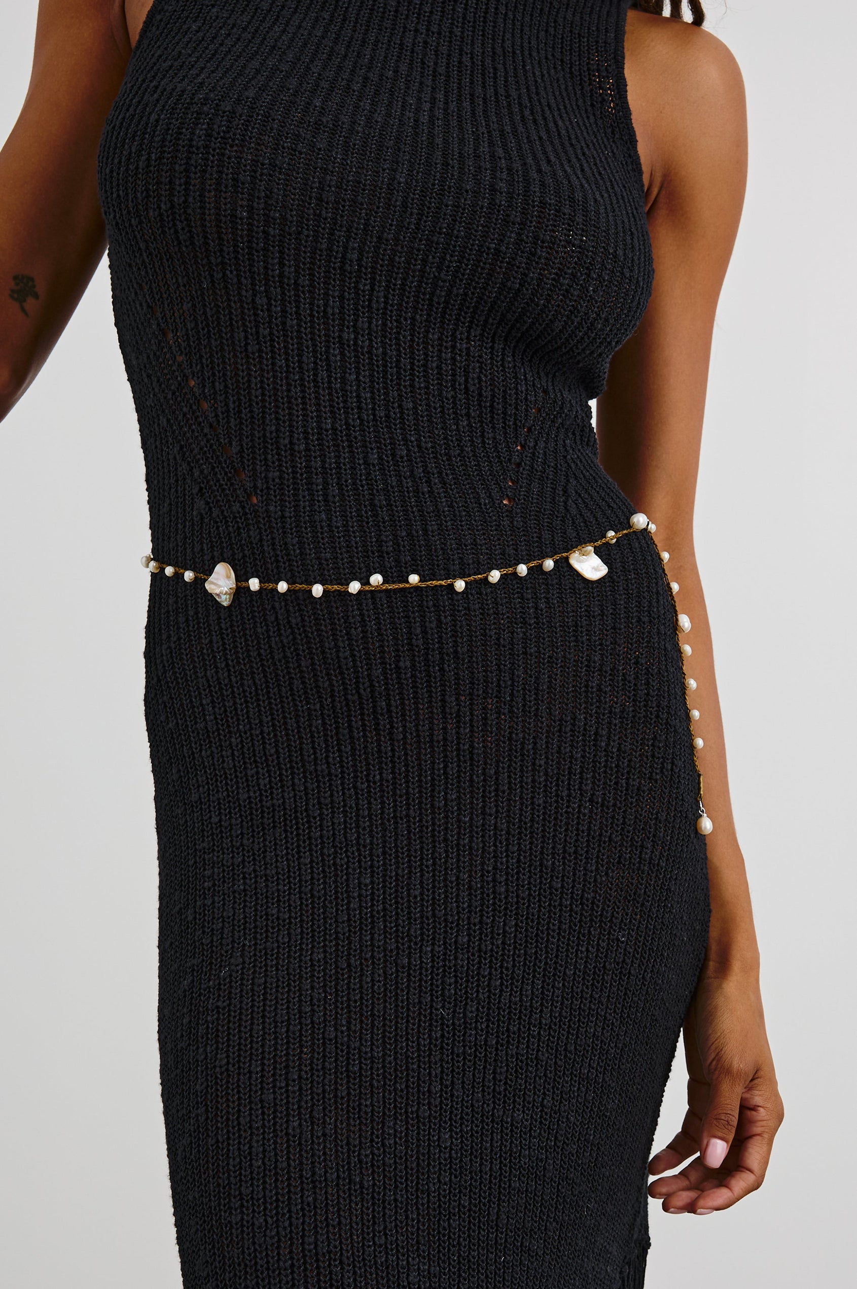 Ariel Cotton Belt with Small Shells Spaced along the Entire Belt and a Dangling End in Fern Natural Shell Colorway - Front View Featured on Model 