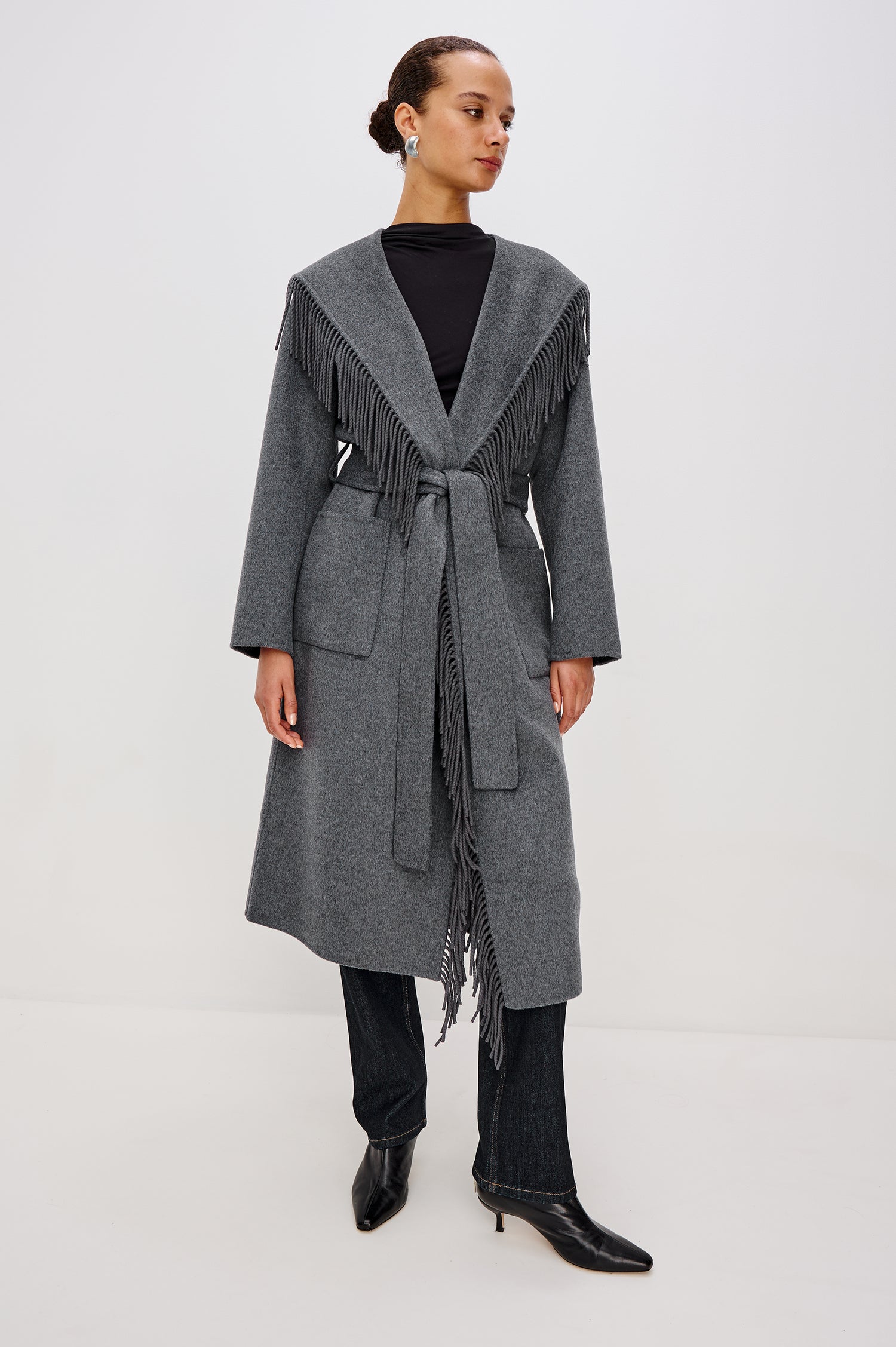 Arlon Coat in Wool Blend With Hood, Shawl Collar, Fringe Trim, Adjustable tie belt, Side Patch Pockets, and Long Sleeves in Heather Charcoal Colorway - Full Body Front View Featured on Model