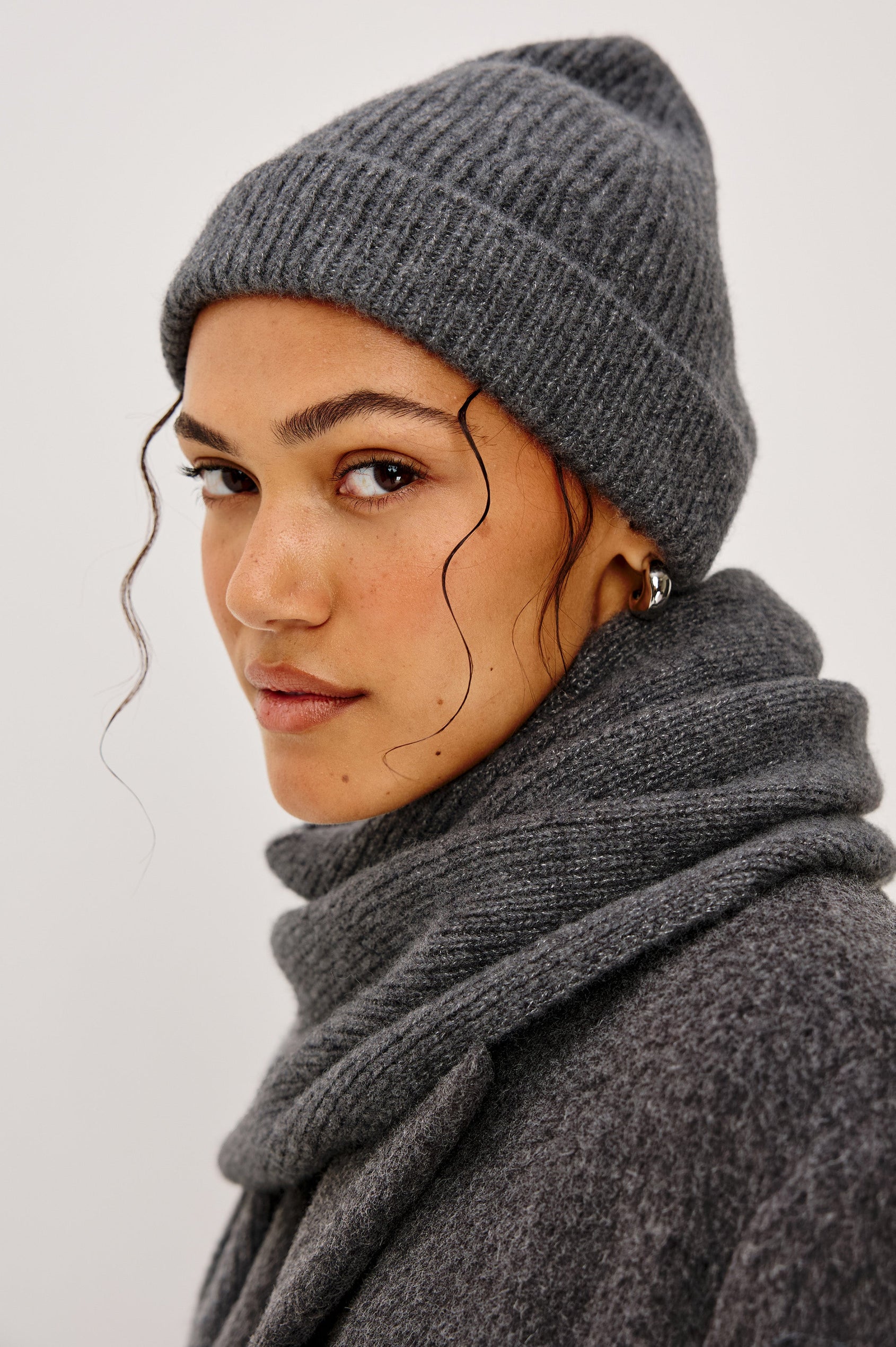 Autumn Cashmere Silk Cuffed Beanie in Thunder Colorway. Side view featured on model.