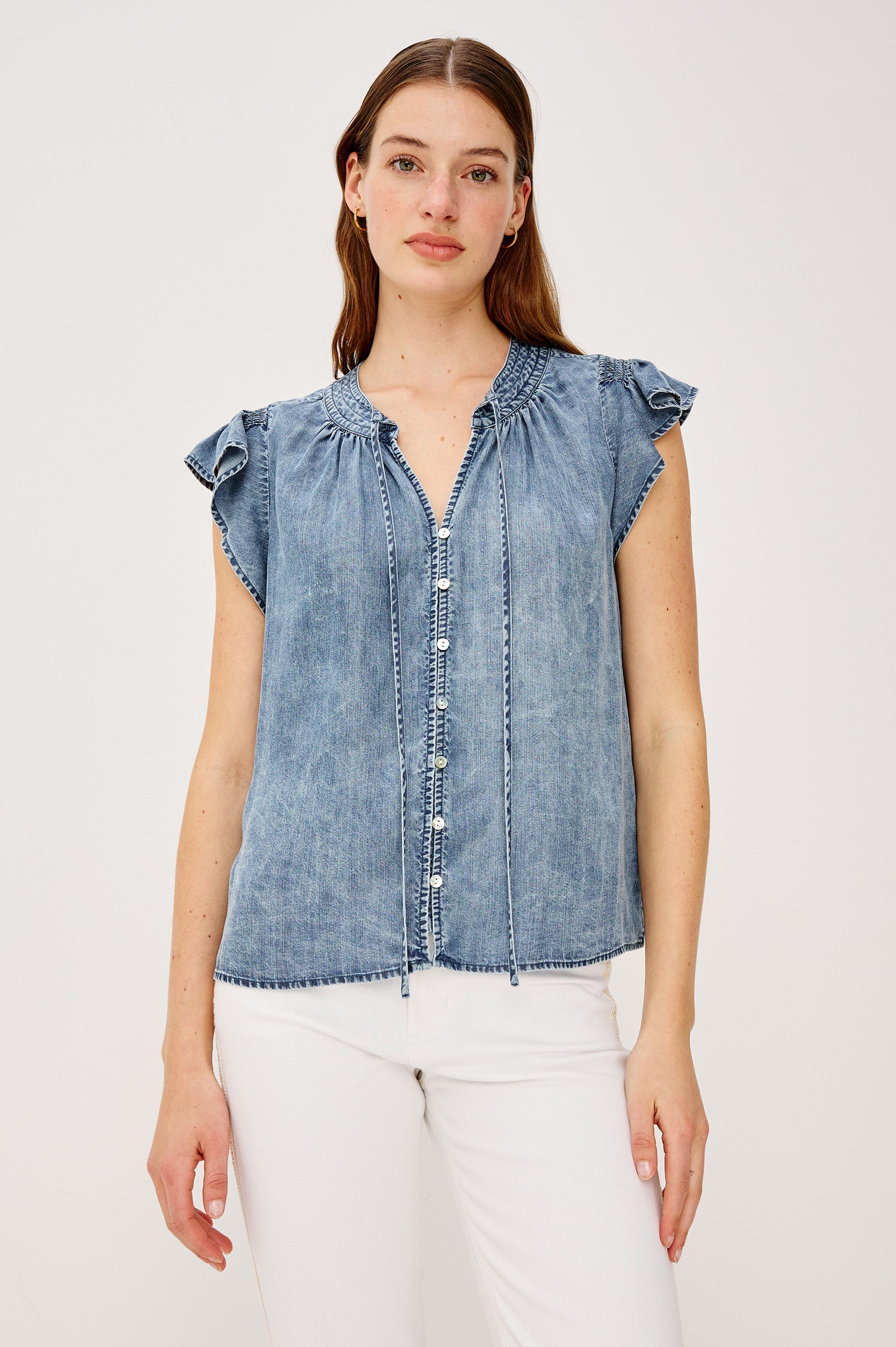 Aviva Top in TENCELâ„¢ Denim With Smocked Flutter Sleeves Split V-Neck With Embroidered Collar and Self-Ties and Front Buttons in Blue Ridge Colorway - Upper Body Front View Featured on Model