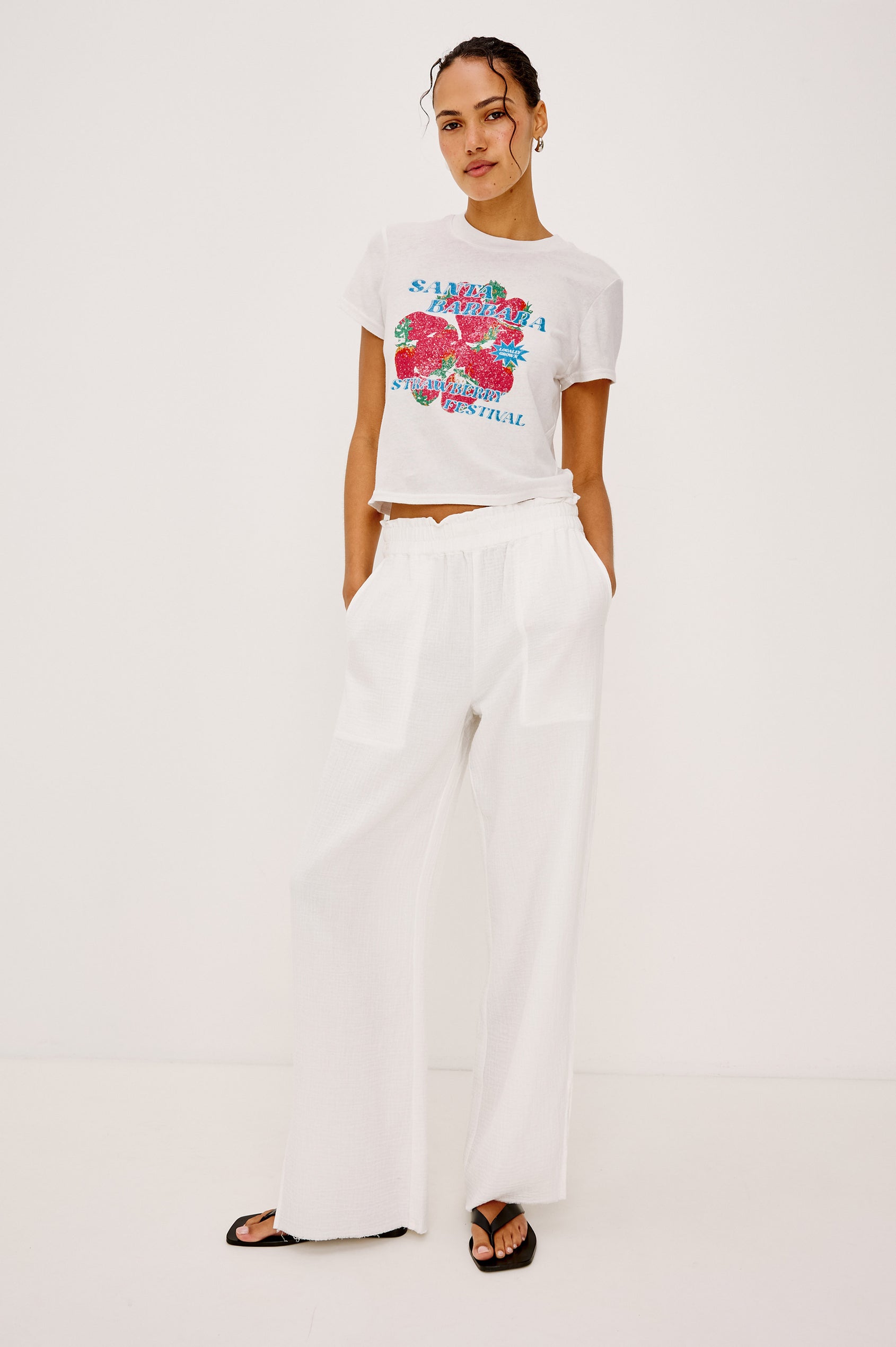 Baby Tee in Cotton With Crew Neckline, Short Sleeves, Boxy, Cropped FIt, and Graphic Print at Front in Santa Barbara Strawberry Festival Colorway - Full Body Front View Featured on Model