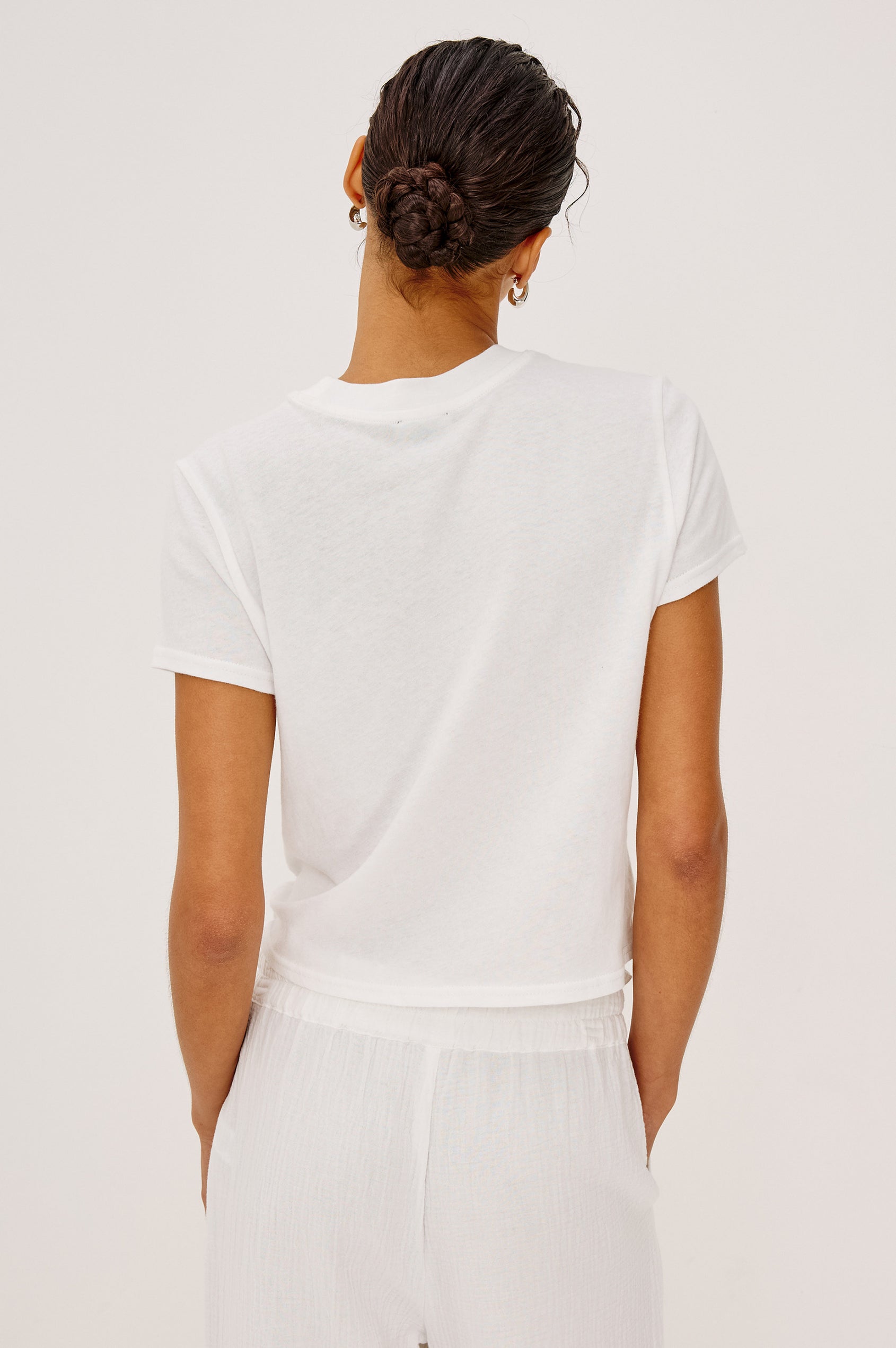 Baby Tee in Cotton With Crew Neckline, Short Sleeves, Boxy, Cropped FIt, and Graphic Print at Front in Santa Barbara Strawberry Festival Colorway - Upper Body Back View Featured on Model