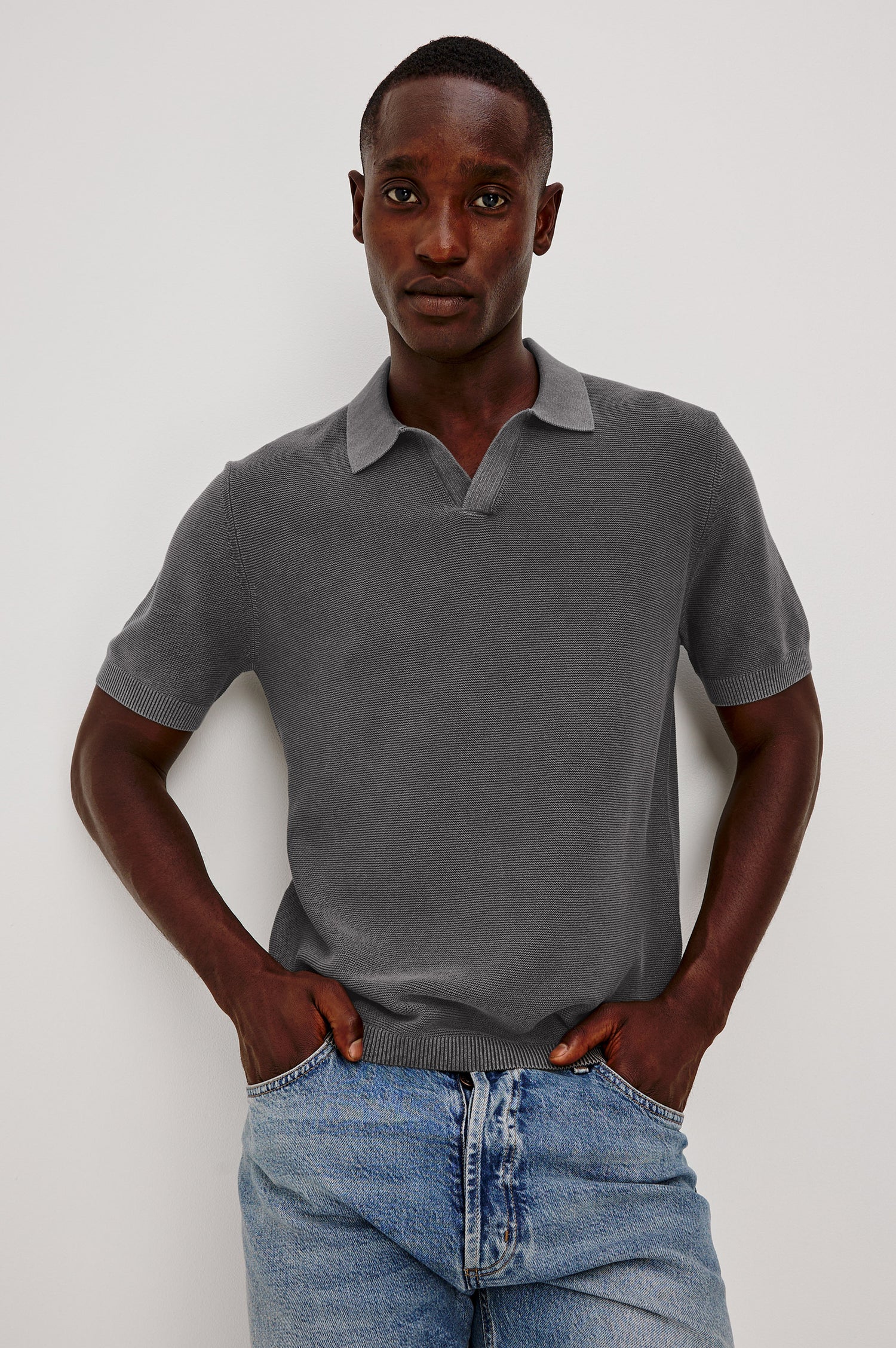 Baker Polo Shirt in Cotton Knit With Sun-Washed Effect, Open-Placket Collar, Short Sleeves, and Relaxed Fit in Sunfaded Black Colorway - Upper Body Front View Featured on Model