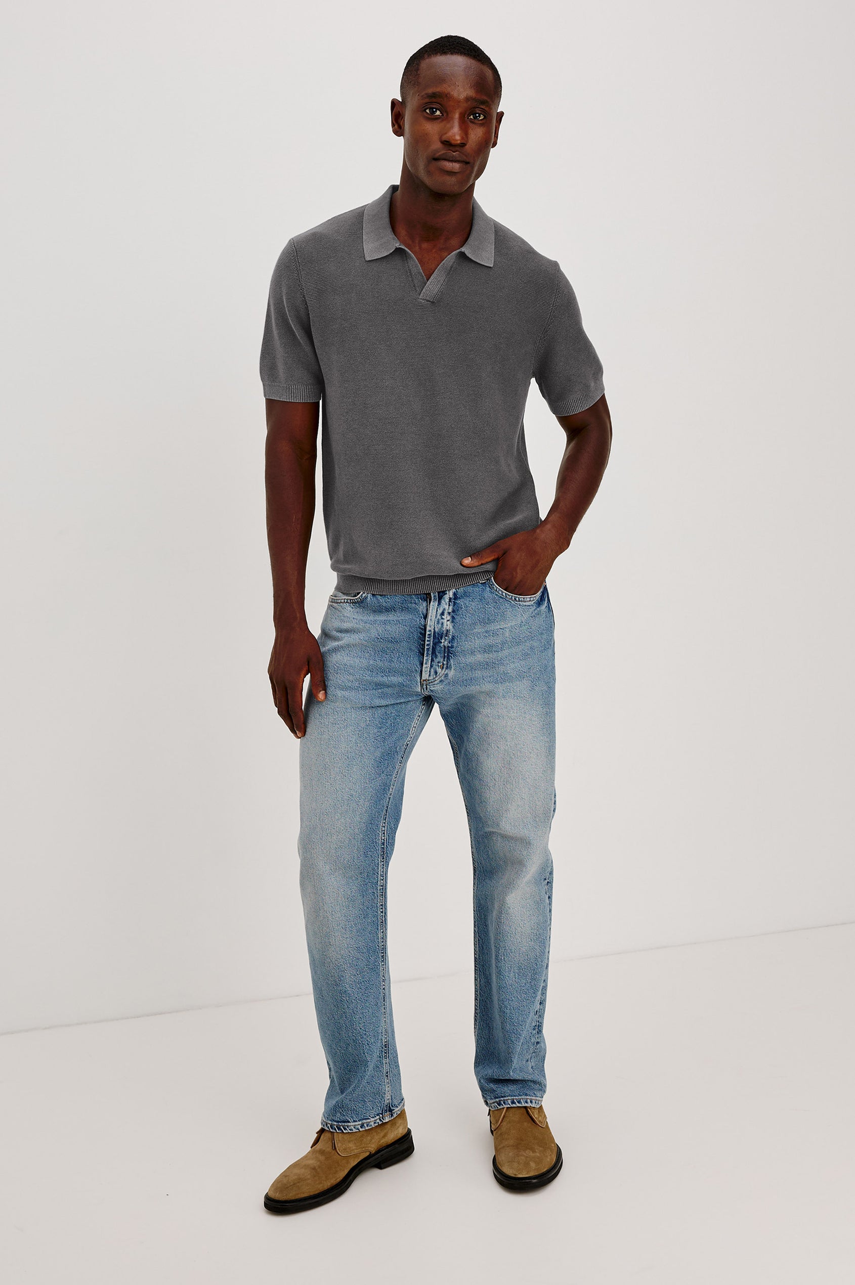 Baker Polo Shirt in Cotton Knit With Sun-Washed Effect, Open-Placket Collar, Short Sleeves, and Relaxed Fit in Sunfaded Black Colorway - Full Body Front View Featured on Model