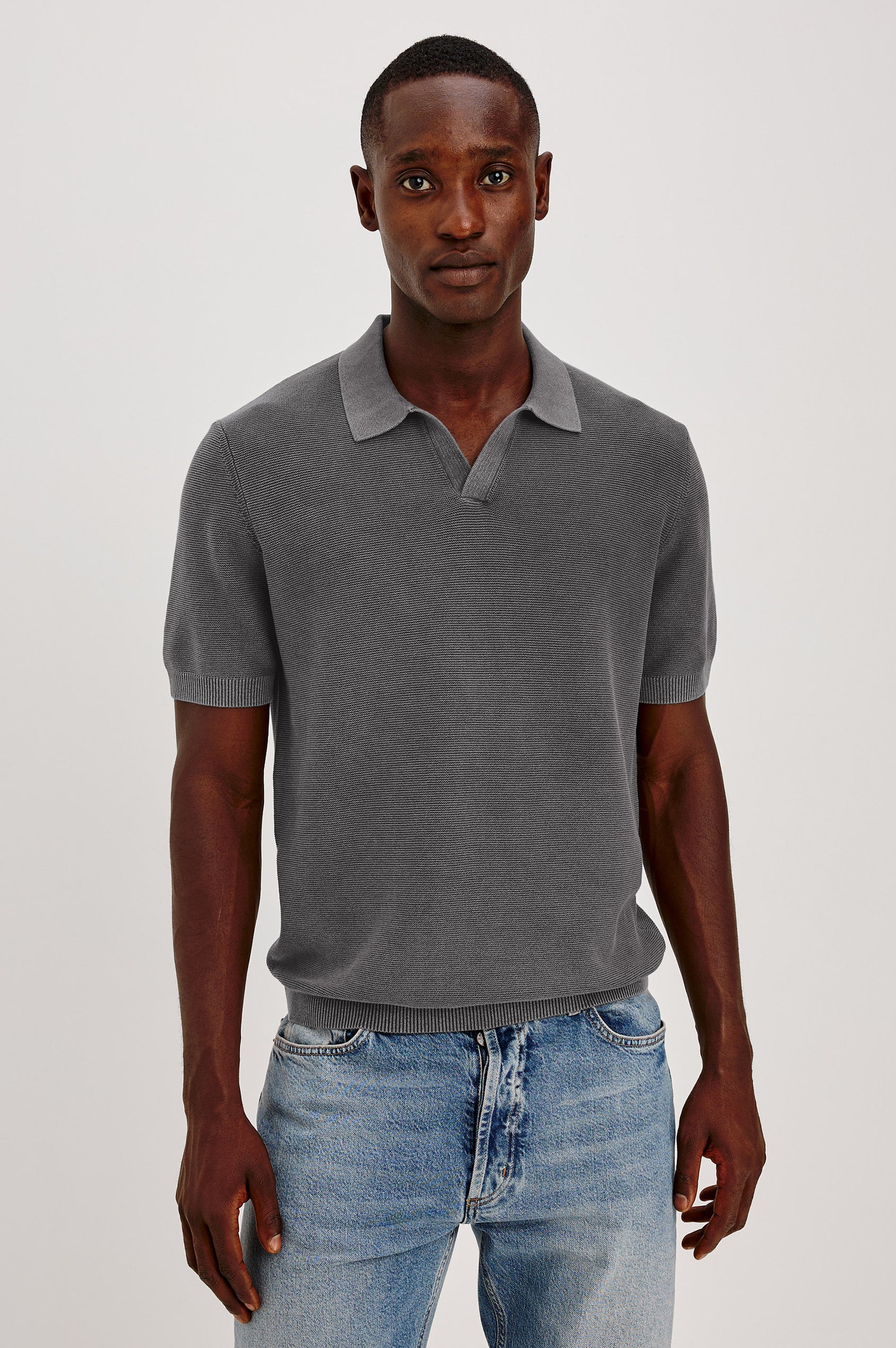 Baker Polo Shirt in Cotton Knit With Sun-Washed Effect, Open-Placket Collar, Short Sleeves, and Relaxed Fit in Sunfaded Black Colorway - Upper Body Front View Featured on Model