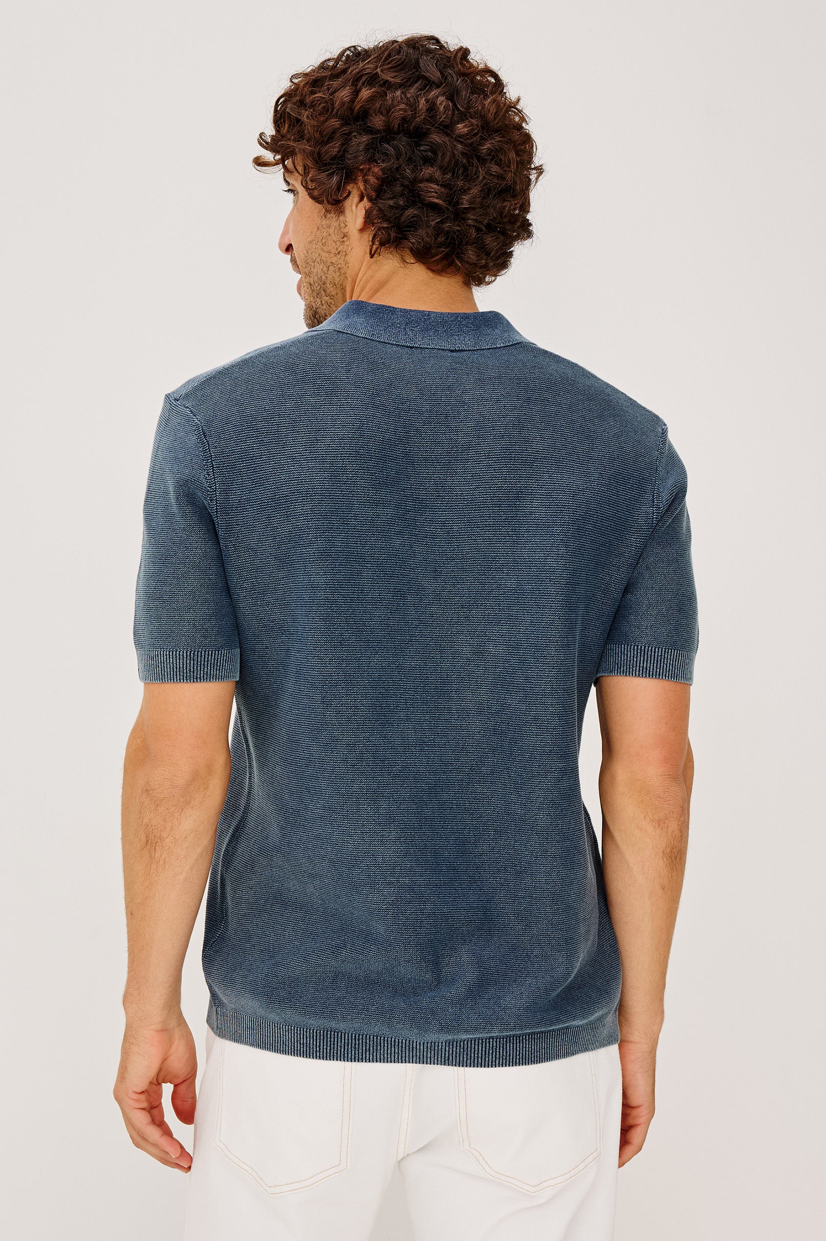Baker Polo Shirt in Rib Cotton Knit With Colar, Short Sleeves, and Relaxed Fit in Sunwashed Navy Colorway - Upper Body Back View Featured on Model