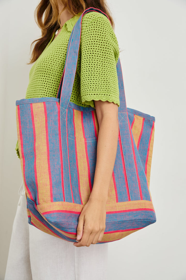 Striped linen Beach Tote with front pocket and long, wide shoulder straps in Rio Stripe - close up of bag, model carrying over shoulder