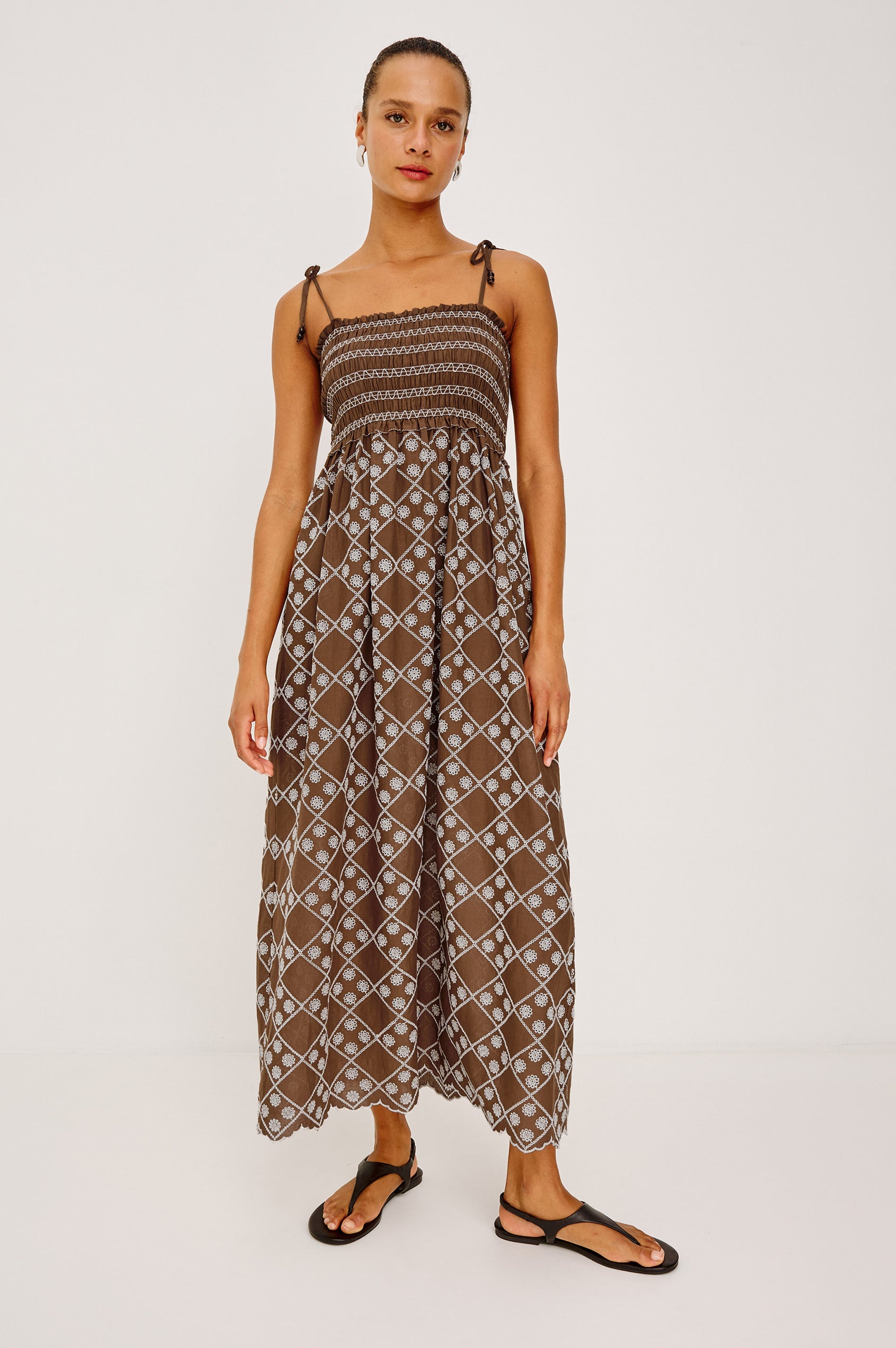 Becca Maxi Dresss in Cotton Voile Wih Beaded Adjustable Shoulder Ties, Straight Neckline, Smocked Bodice, Empire Waist, and Full Skirt in Cocoa Daisy Embroidery - Front View Featured on Model